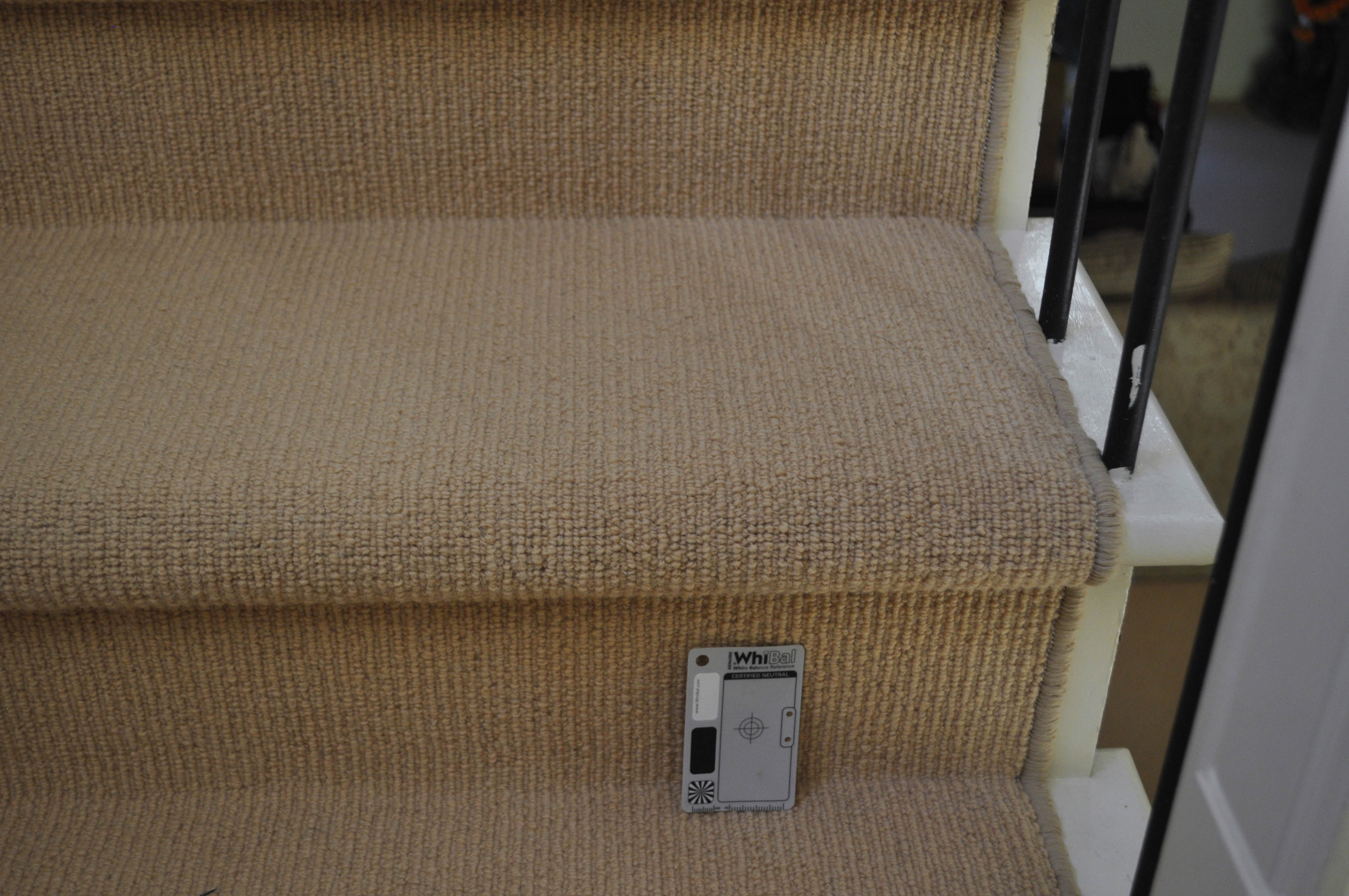 showing a staircase with it's floor carpeted, the carpet being of an orange color, sisal tram trek pile, wool yarn carpet on sale at Concord Floors