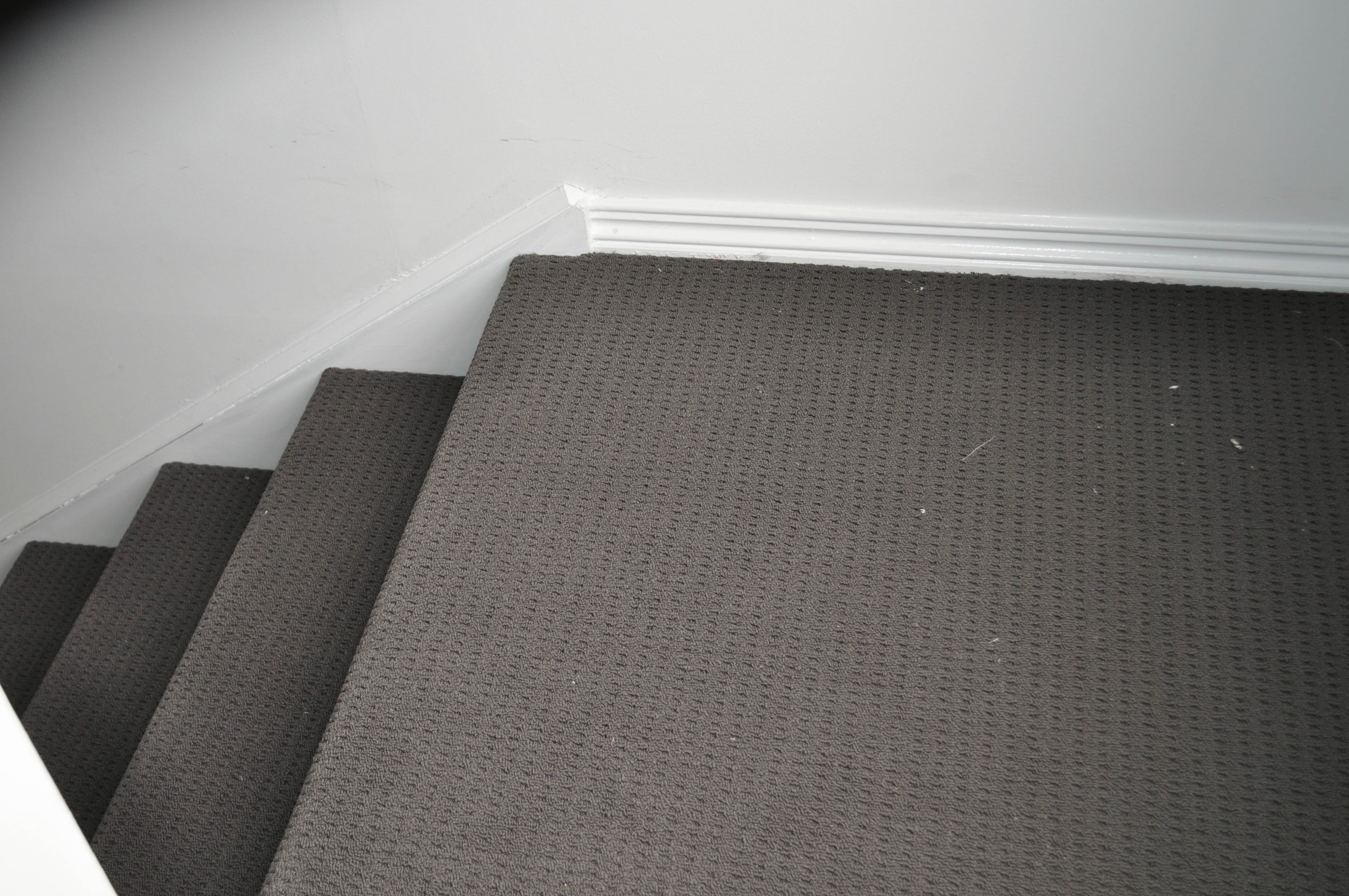 showing a staircase in a Werribee home with carpet on, it being of a  beige color, embossed loop pile, nylon yarn carpet on sale at Concord Floors.