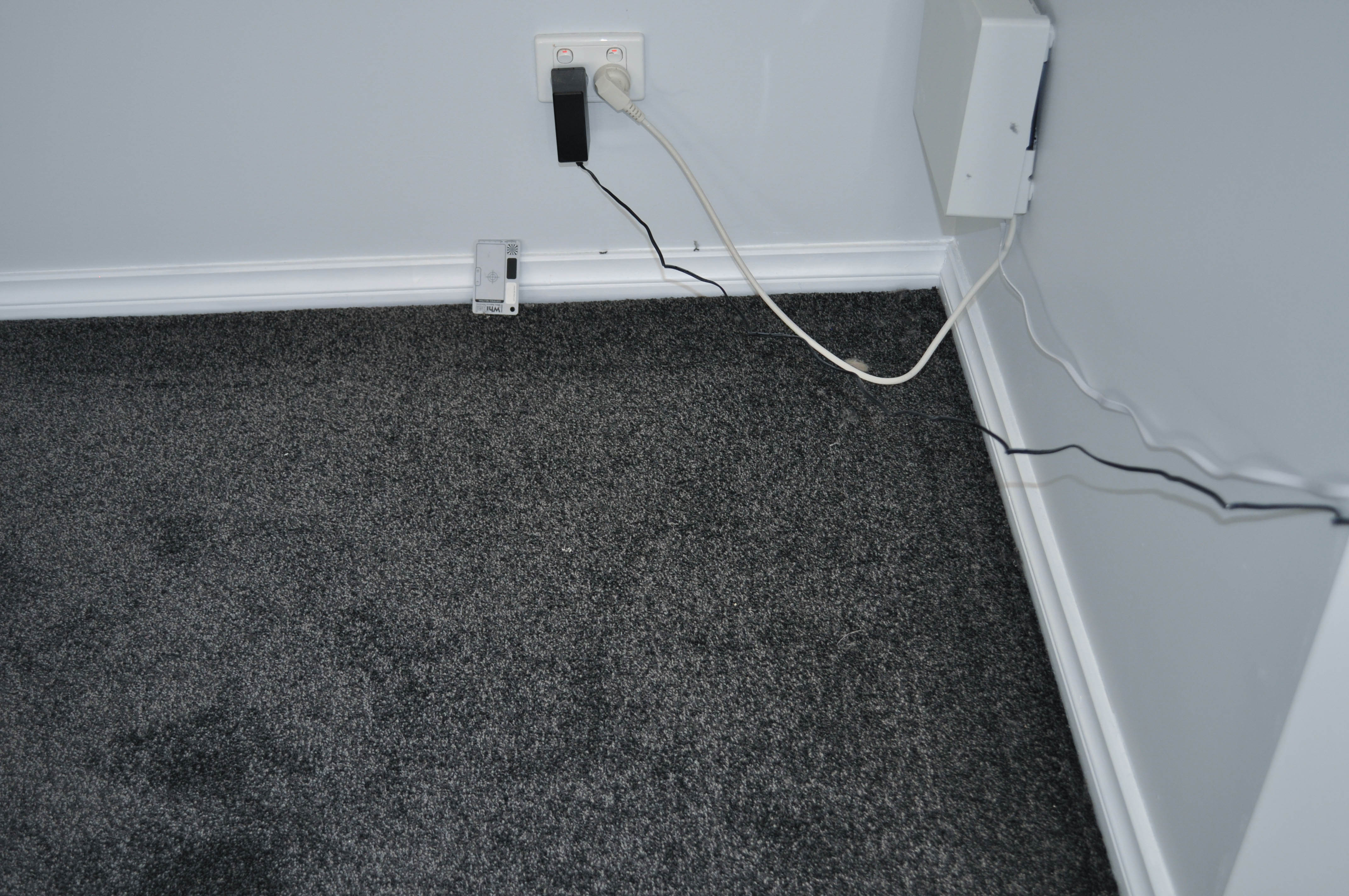 showing a room in a melton house, and it's floor carpeted by a, black coloured twist pile, polyester yarn carpet, installed by Concord Floors.