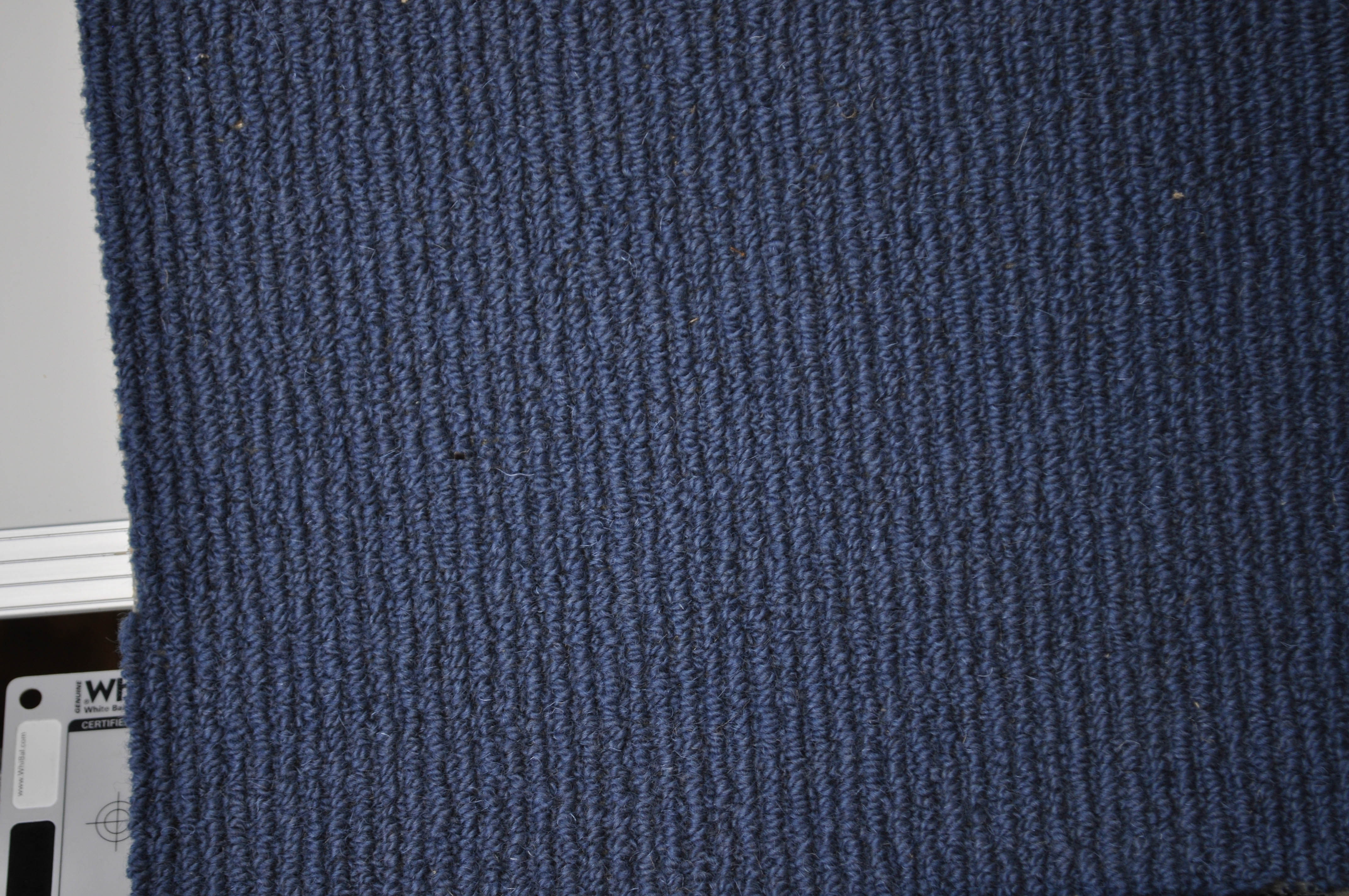 showing a sample piece of blue coloured, wool sisal tram trek pile carpet on sale at Concord Floors.