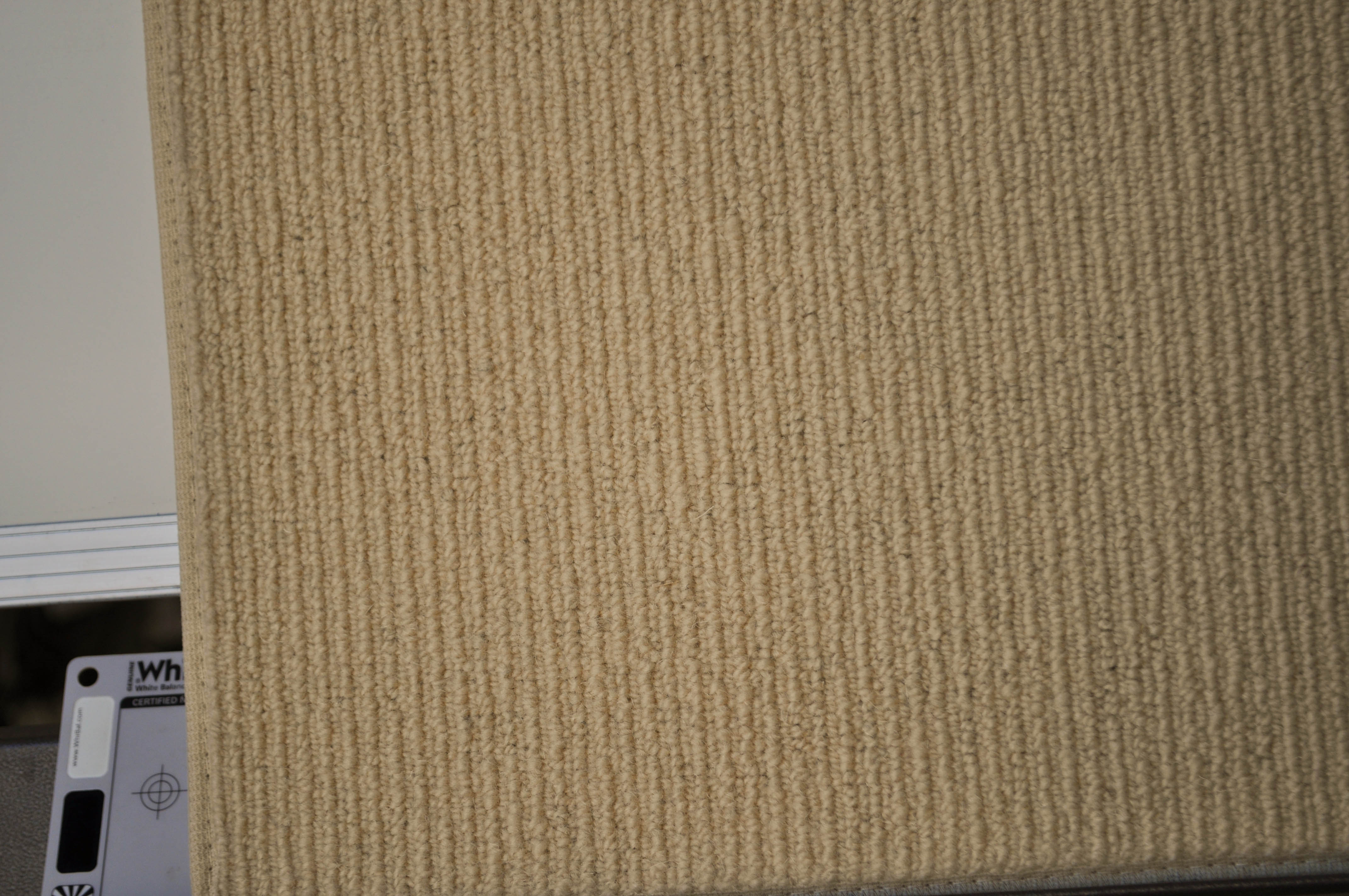 showing a sample of carpet, it being of a  cream color, tram trek, wool yarn carpet on sale at Concord Floors.