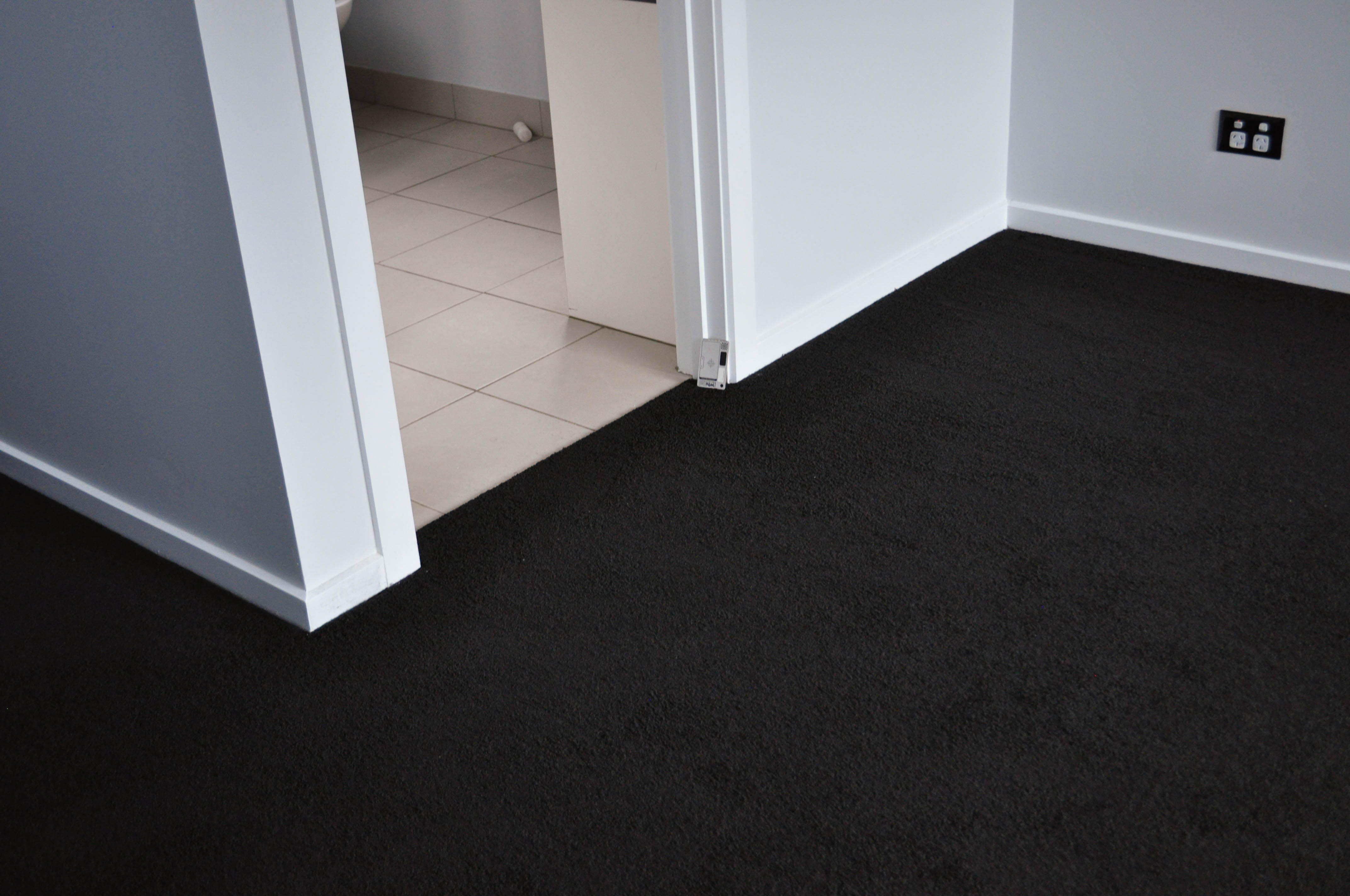 showing carpet on a floor, black color, in a home in Derrimut supplied and installed by Concord Floors.