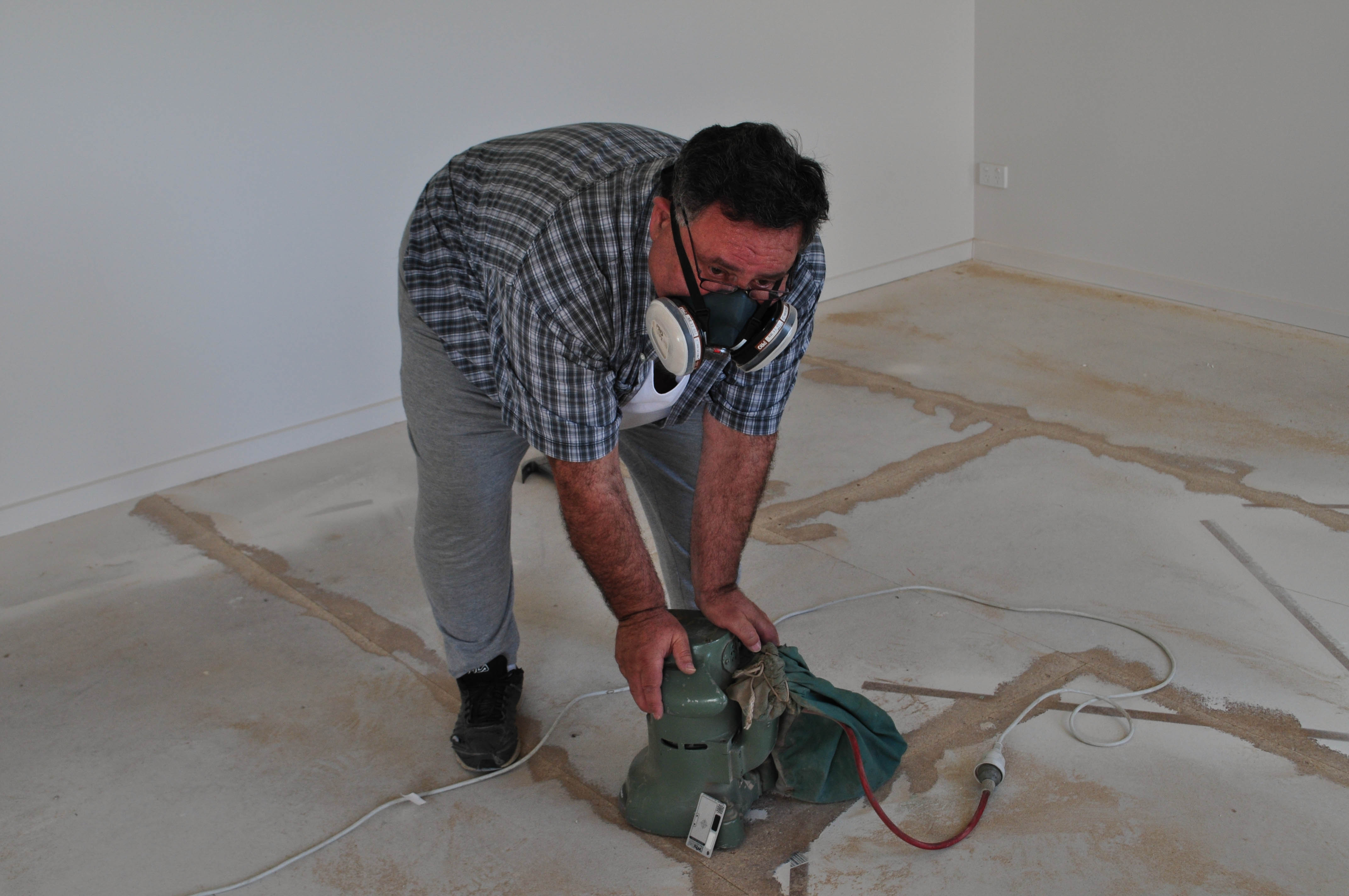 a floor in a room, in a house in Point Cook, Werribee where the timber floor boards have cupped and the
 cupping is been sanded down with an edge sander Concord Floors.