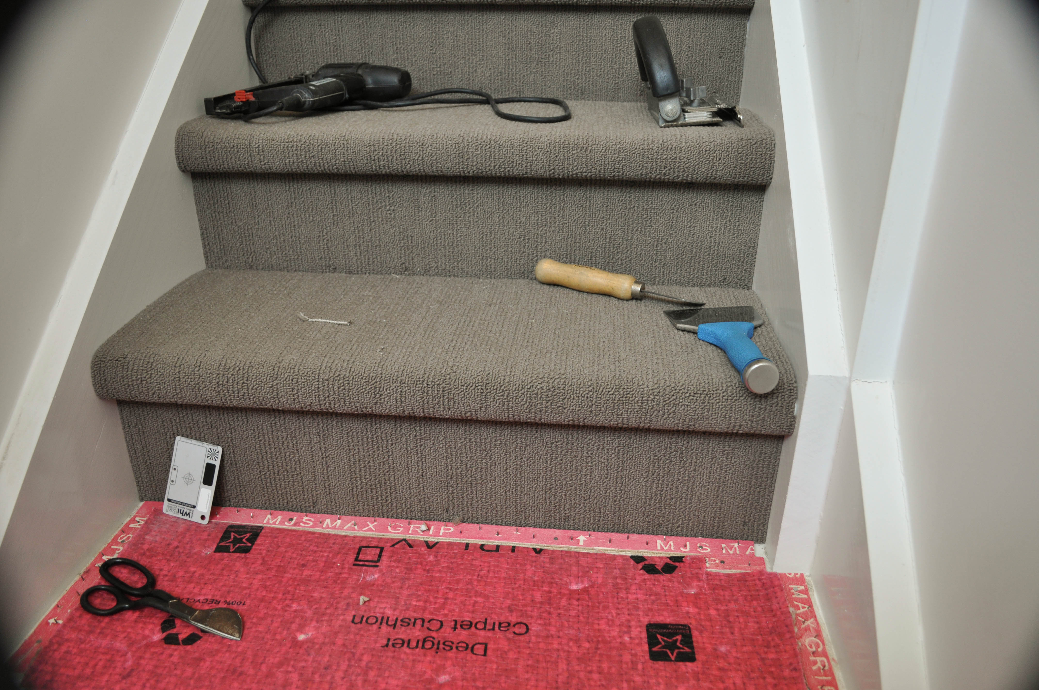showing the tools, electic tacker, carpet trimmer, hookbill knife and stair tool, and where one step where the gripper and underlay has been installed,
 and two steps that have been laid by Concord Floors in a house in Point Cook, Werribee, Vic 3030.