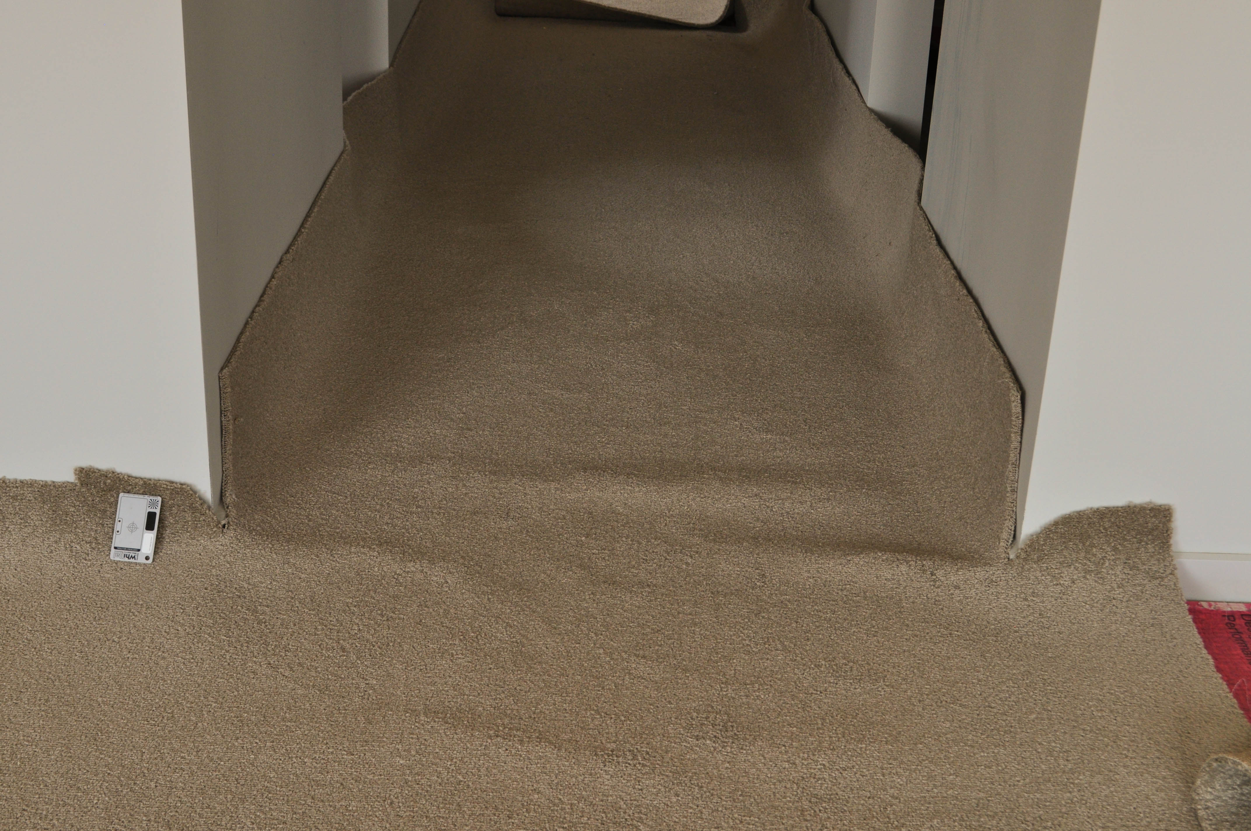 a slab of new carpet being laid with carpet ripples in it, in a room with a passage running of it in a home in Hoppers Crossing.