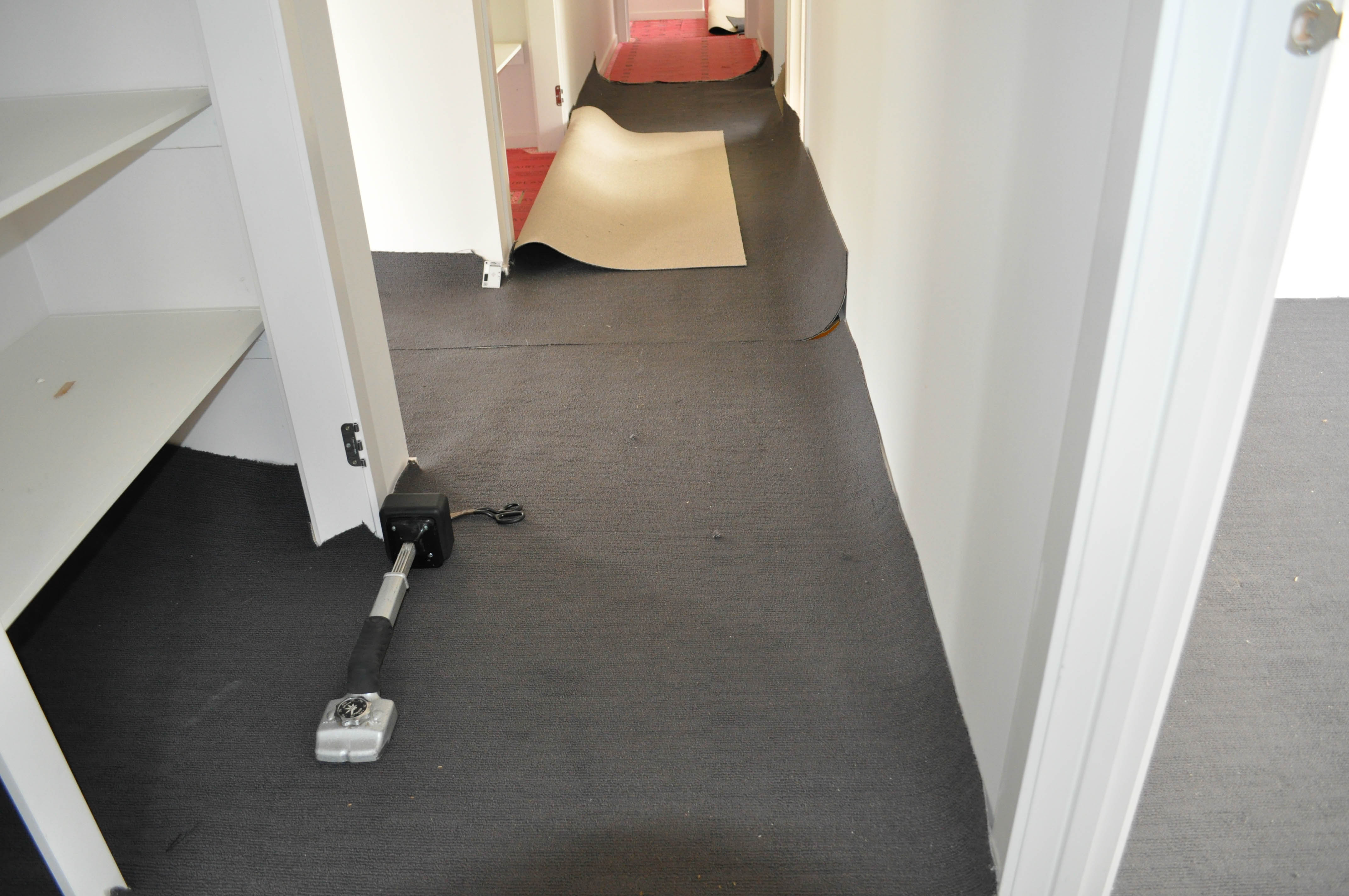 slabs of carpet in a passage prepared for joining by Concord Floors in a house in Werribee, Vic 3030.