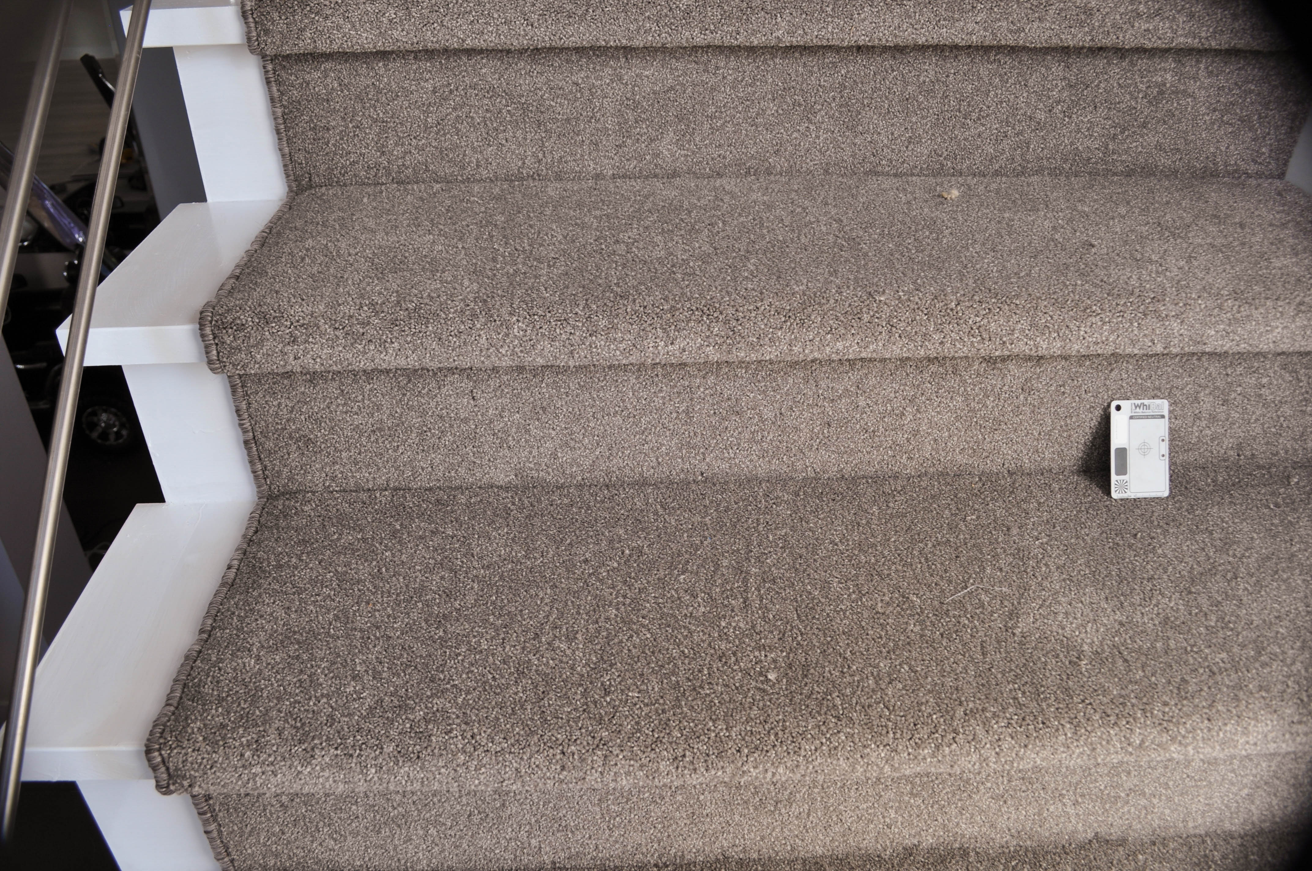 showing a staircase in which the carpet installer Concord floors installed a twist pile carpet of a beige color, which has a rating of extra heavy duty including stairs.