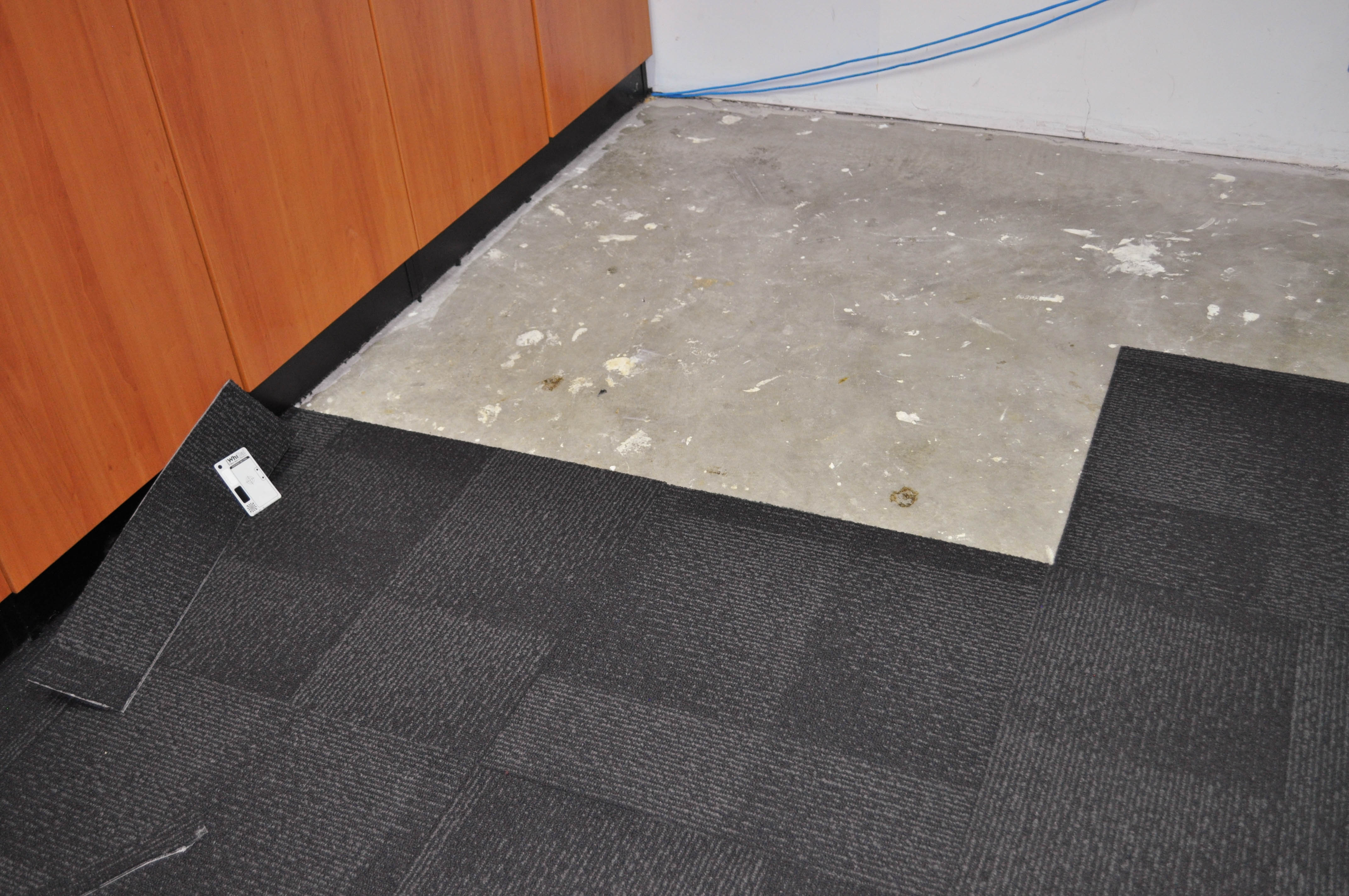 patterned, charcoal colored, carpet tile sample of the Jalan range sold and installed by Concord Floors.
