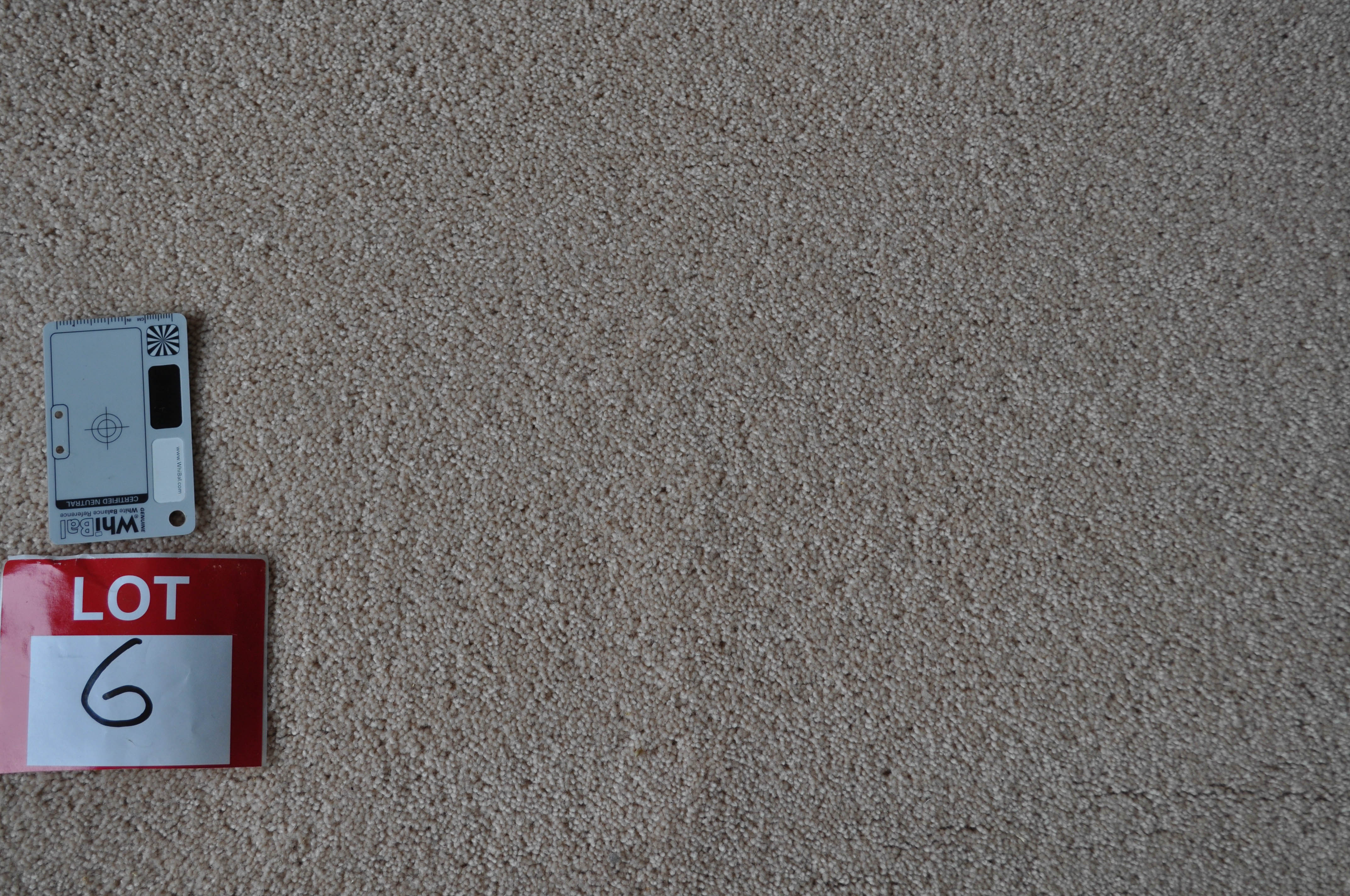 a sample of a wool twist pile carpet, salmon color in a roll in the warehouse of Concord Floors and supplied to the public
 by Concord Floors.