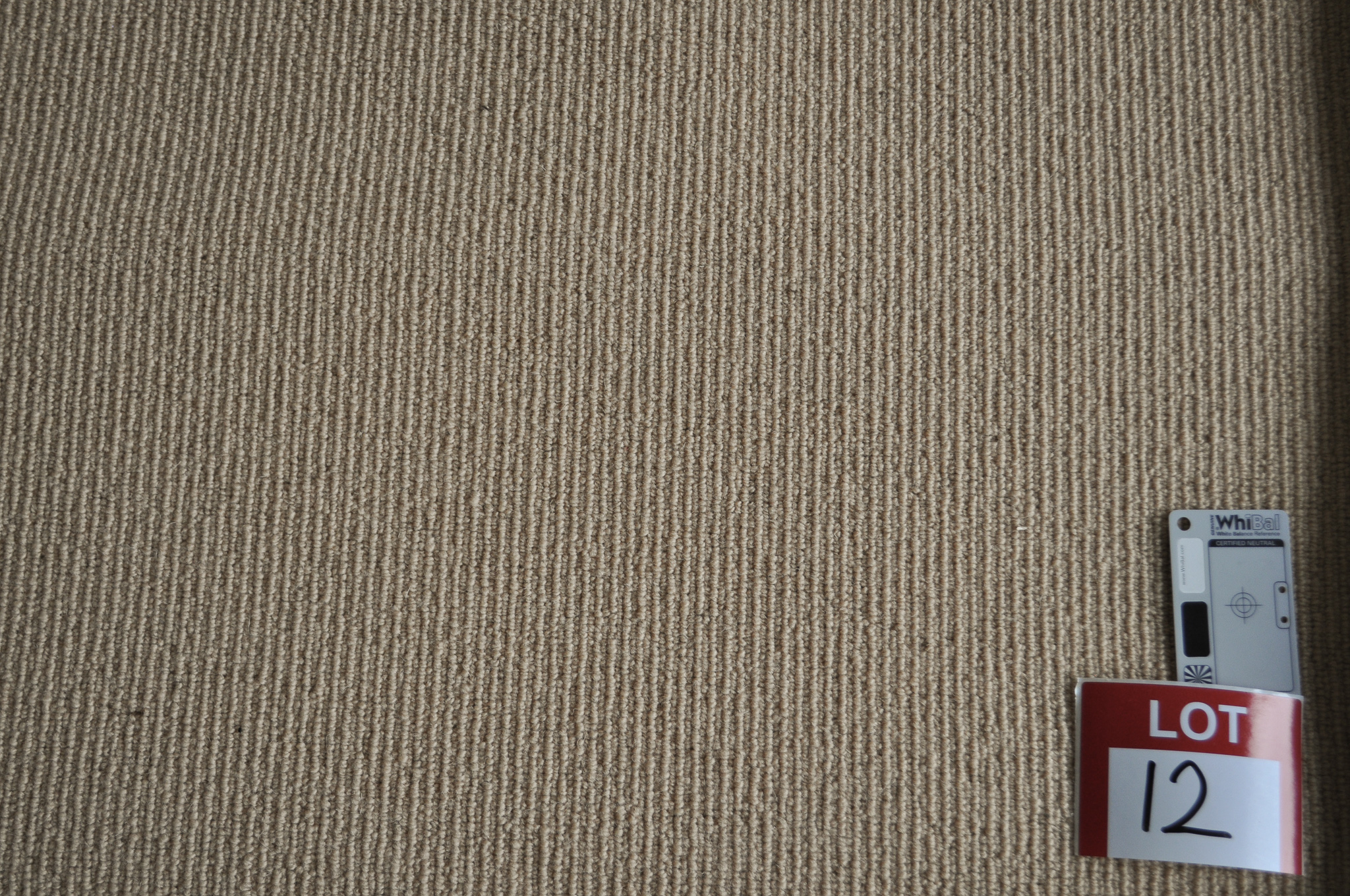a sample of a wool sisal carpet, coffee laite color in a roll in the warehouse of Concord Floors and supplied to the public
 by Concord Floors.