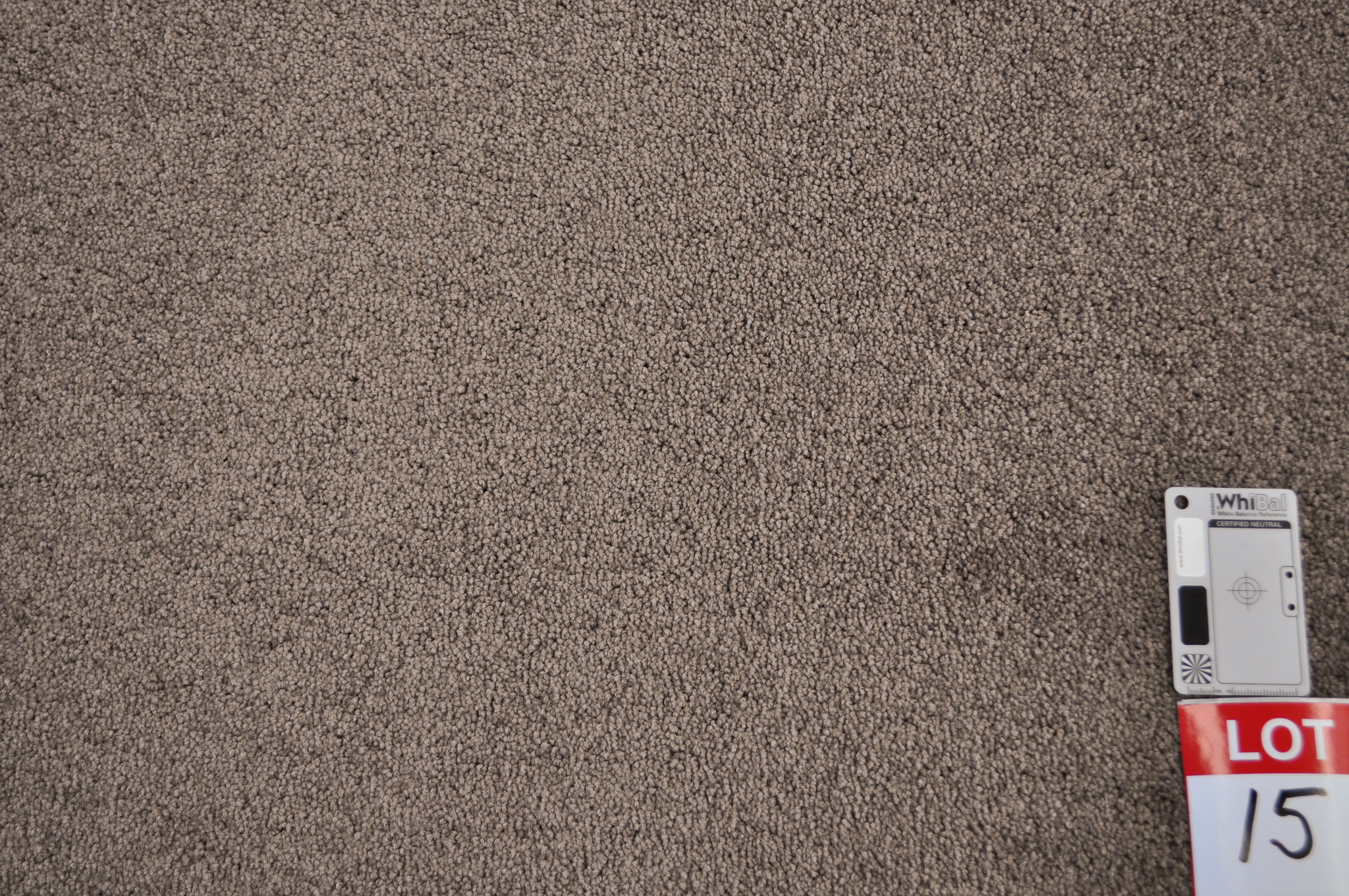  a sample of a dyed nylon carpet, plum color in a roll in the warehouse of Concord Floors and supplied to the public by
 Concord Floors.