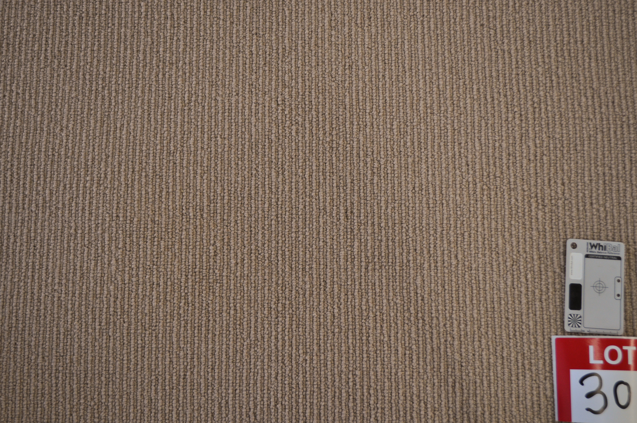 dark beige colored, sisal pile roll of carpet on sale at Concord Floors, it being a remnant roll in Concord Floor's warehouse.