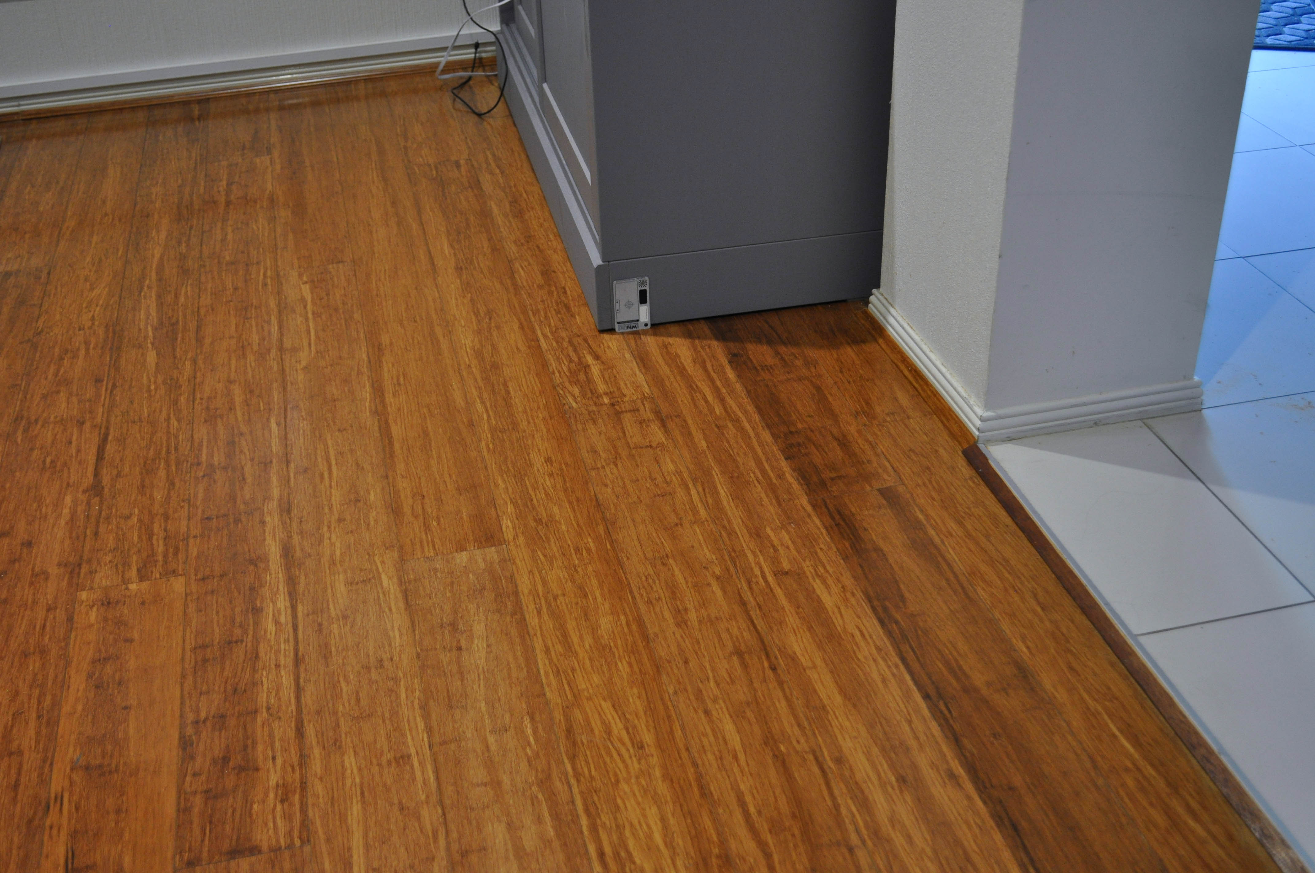 showing a room with a cabinet in it, in a residential home in Caroline Springs, where the flooring in the room is carbonised bamboo sold and installed by Concord floors,
 to the client.