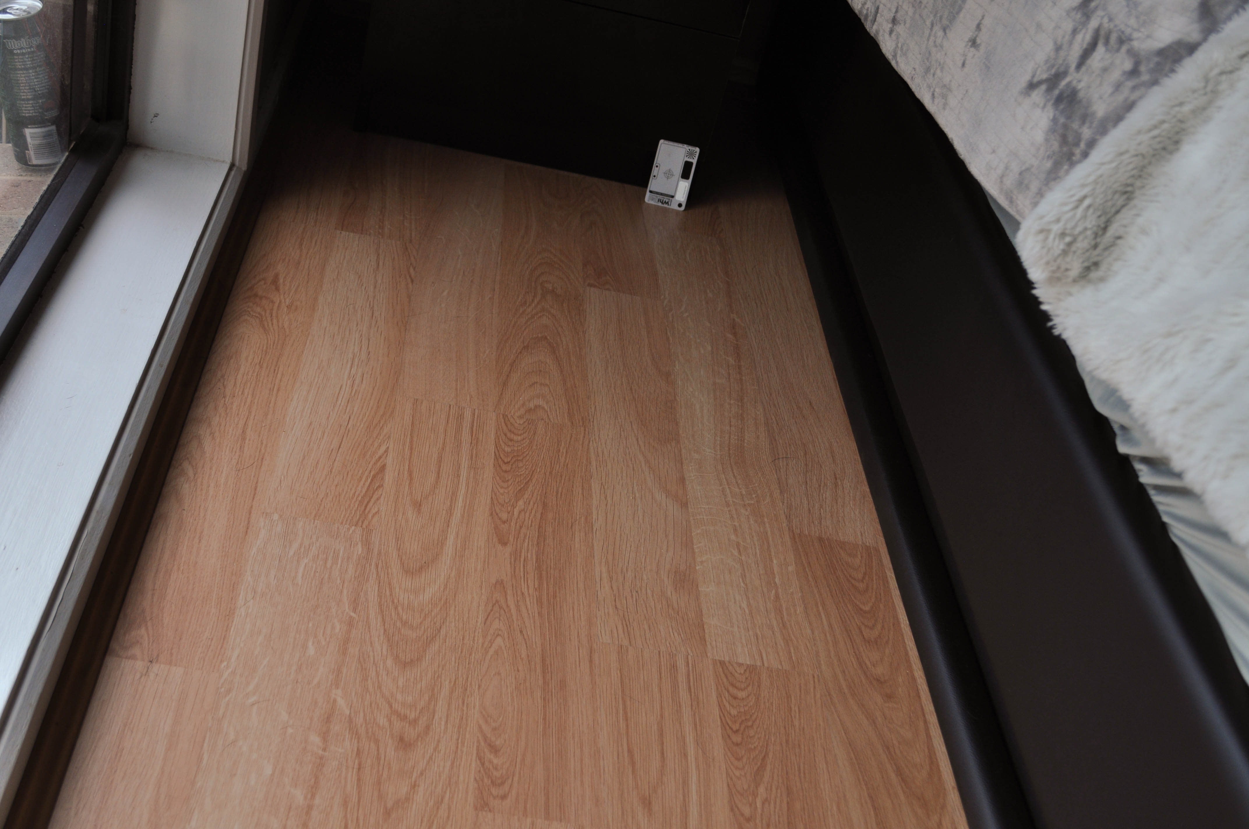 showing a bedromm with a bed in it where a laminate flooring has been installed.
