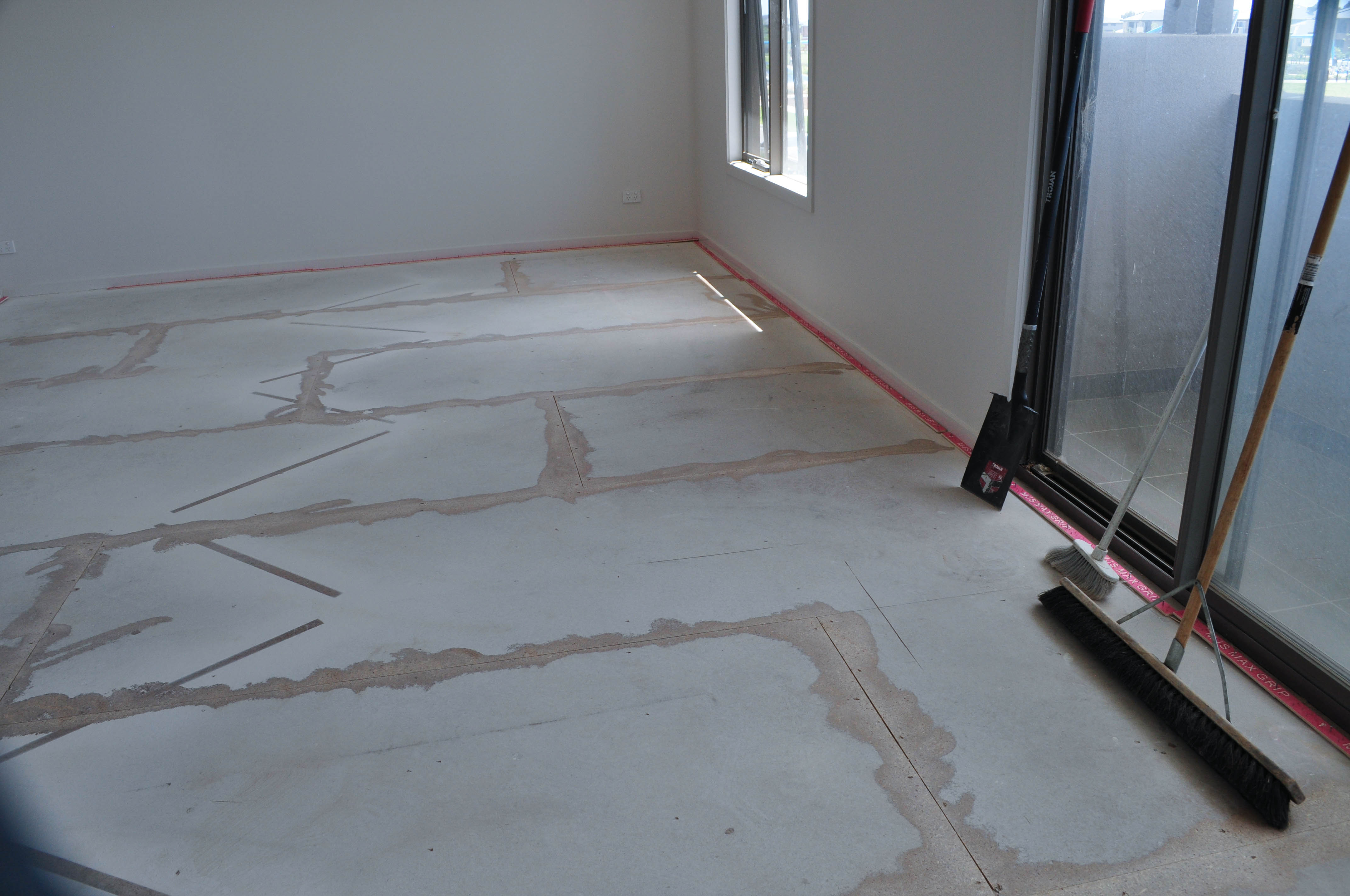 showing a room and its floor where the whole room's floor has been sanded to flatten the cupping particle board edges.