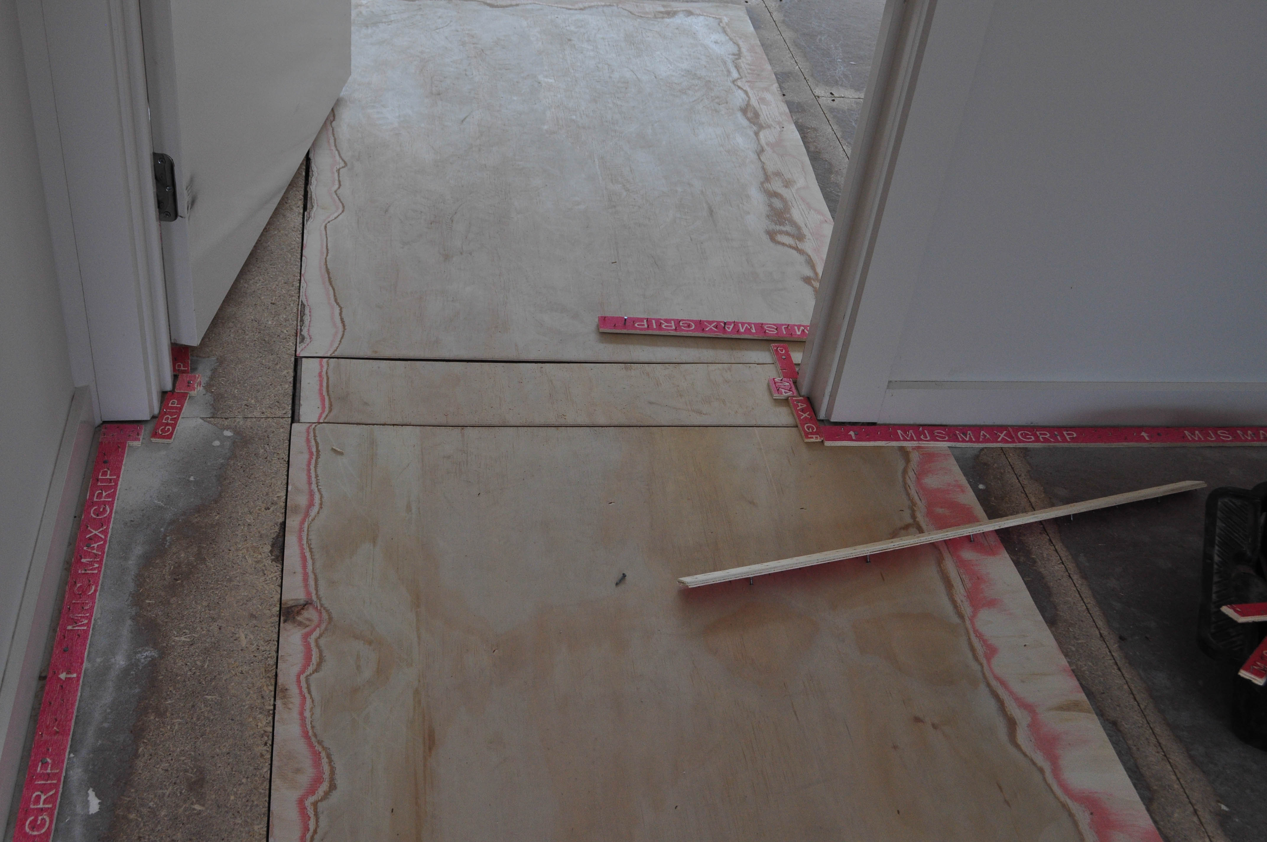 showing the flooring in a room where the left side is higher than the right side and to make it level packing has been used as ramping to bridge the height
 between the two levels.