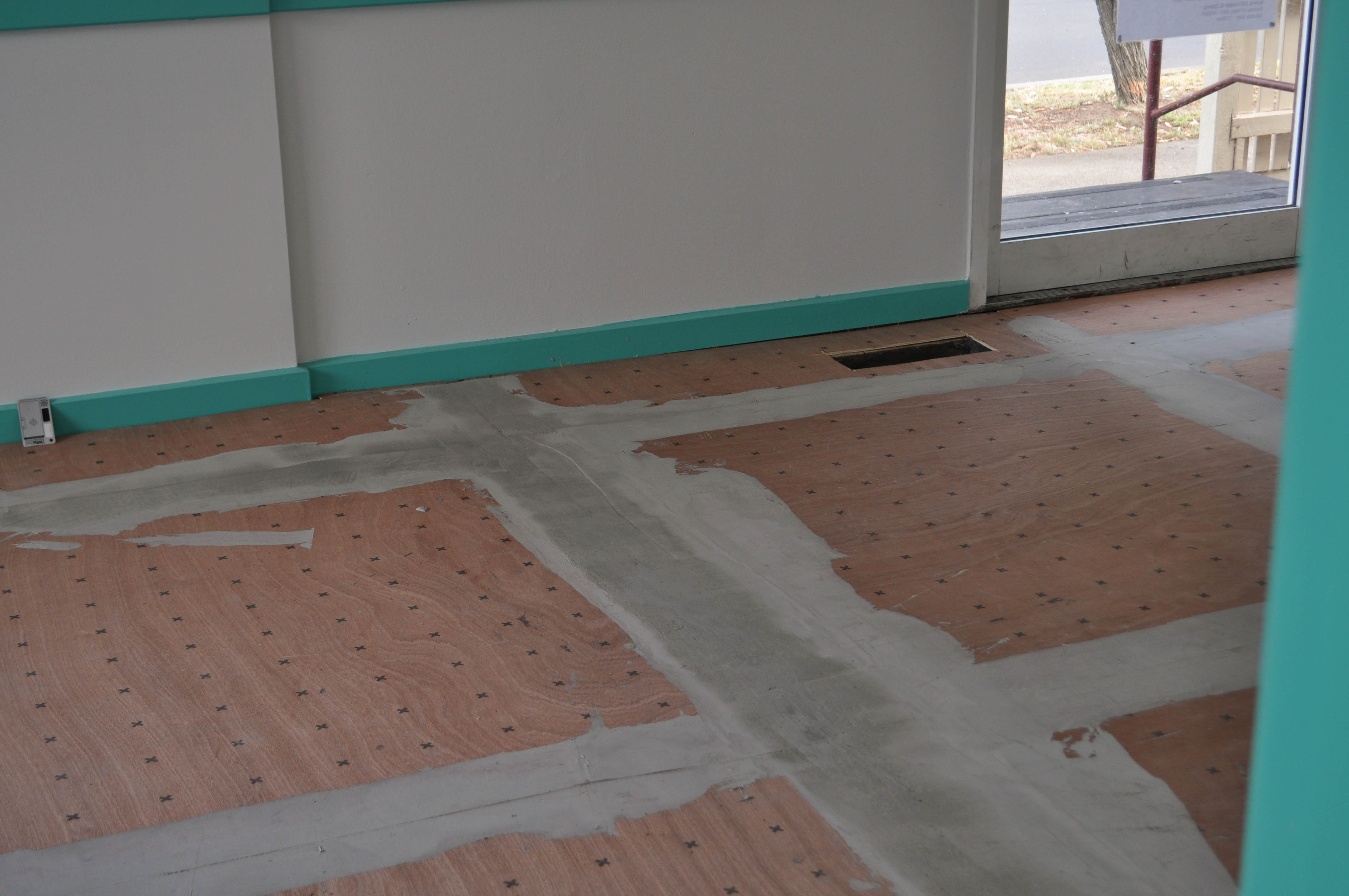 showing a room of which the floor has then been sheeted over with plywood underlay to make it level for the vinyl planks which were installed in a medical
 clinic in Broadmeadows.