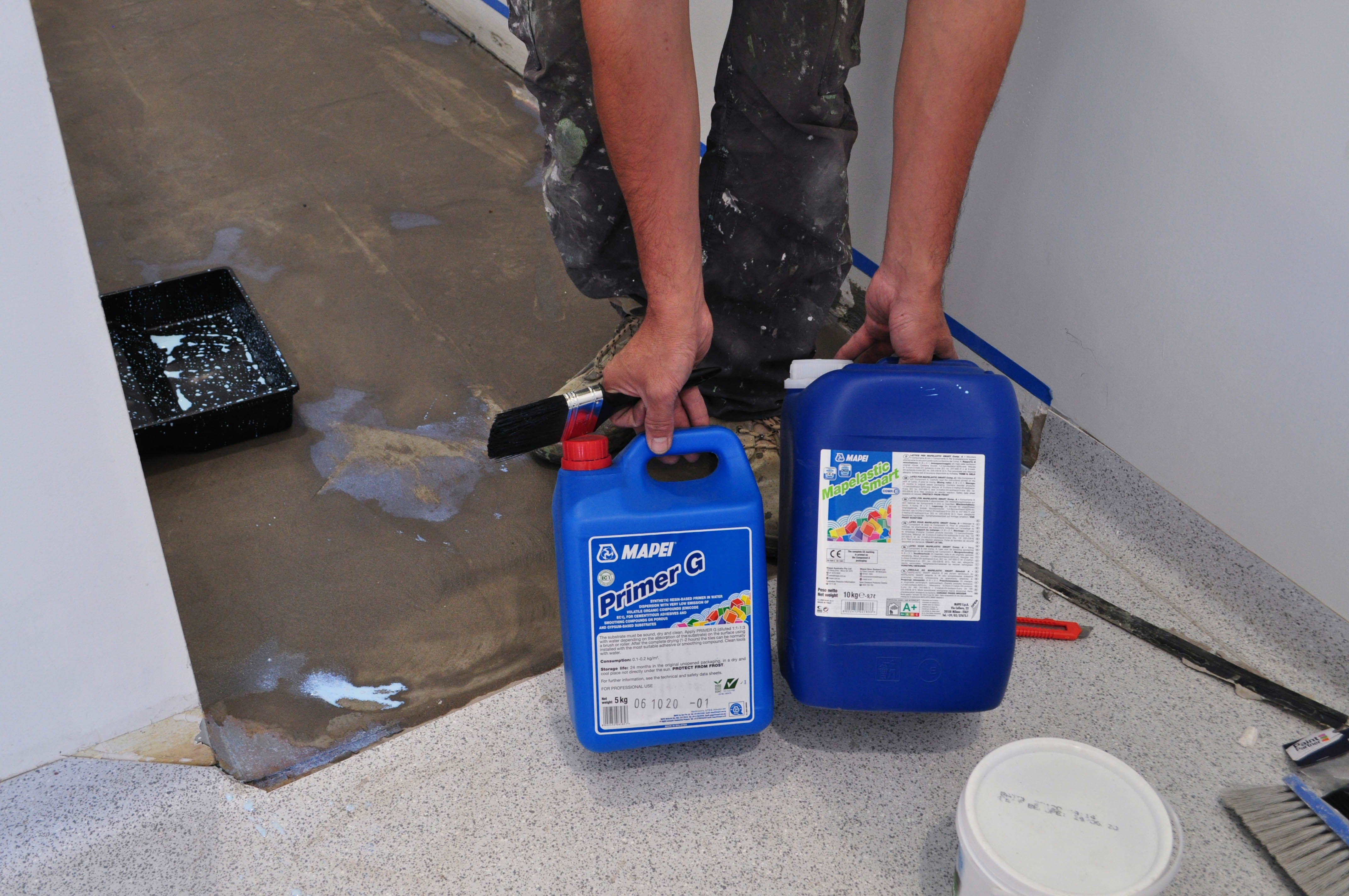 showing a man holding and displaying the primer compounds containers in a toilet.