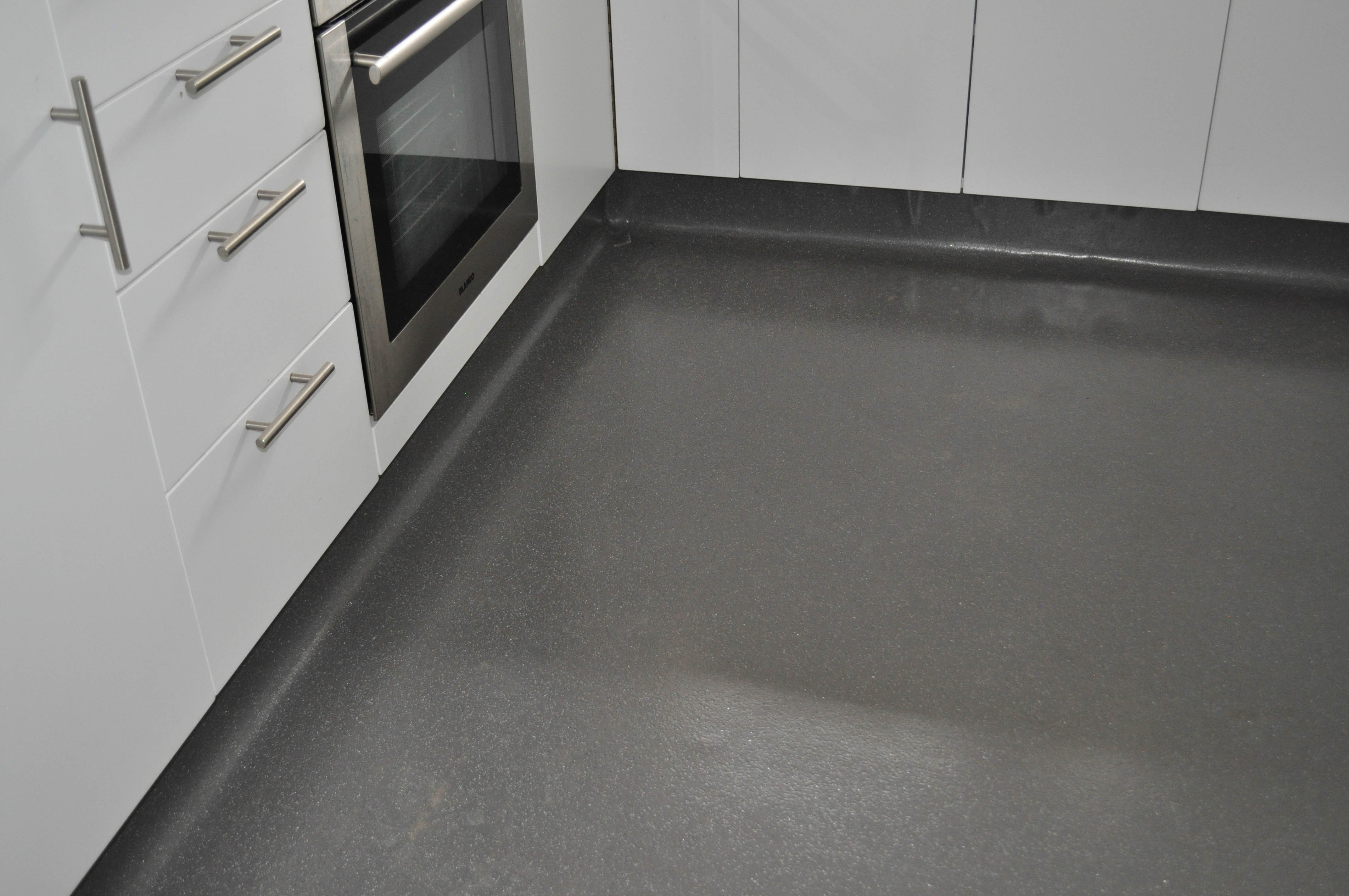 a kitchen in a residential home in Kensington with newly laid grey commercial vinyl flooring. The vinyl flooring was 
	  supplied and installed by Concord Floors