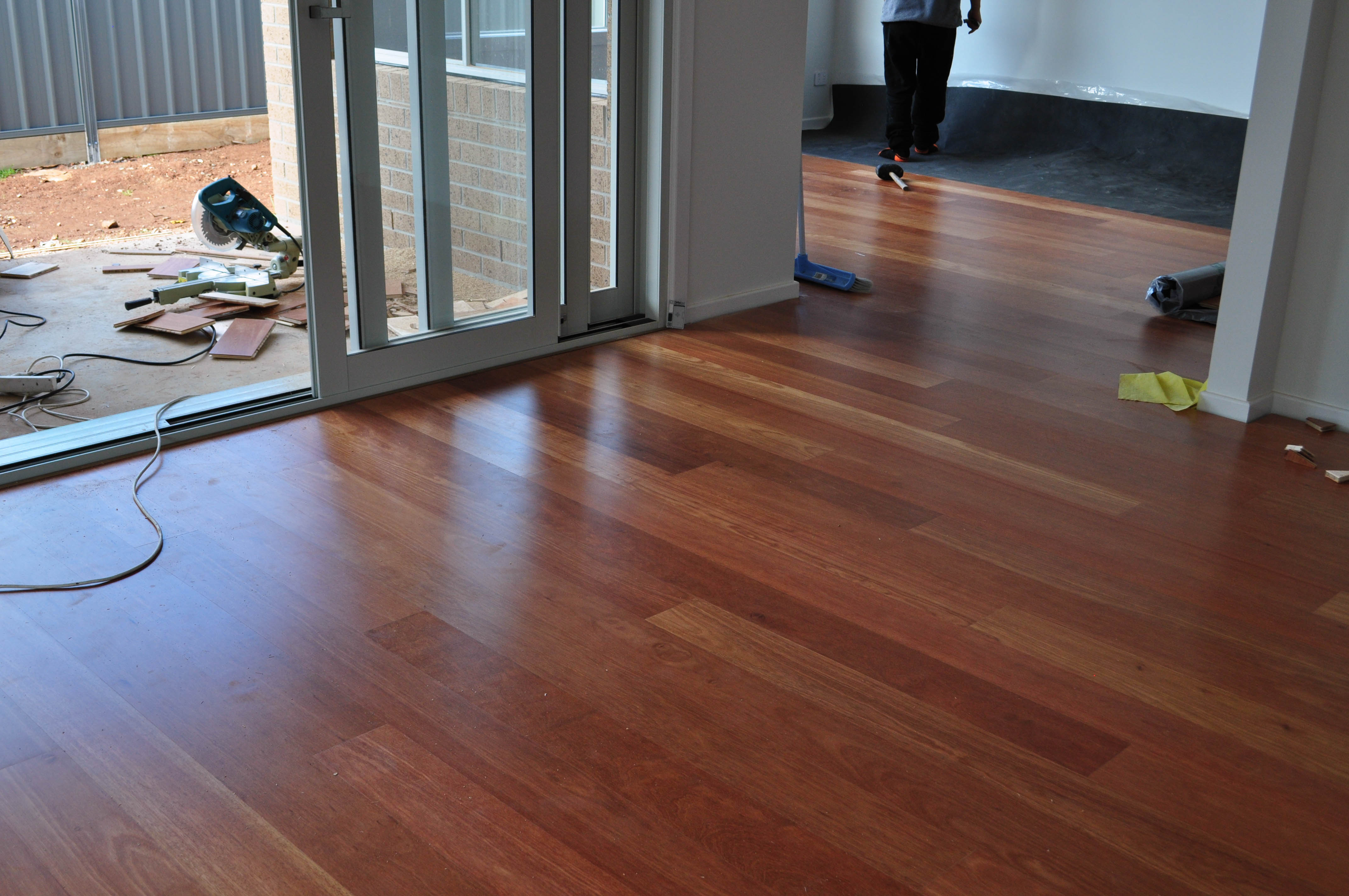in two rooms, a newly installed orange colored engineered laminate flooring, in Melton, Victoria 3337, laid by Concord Floors.