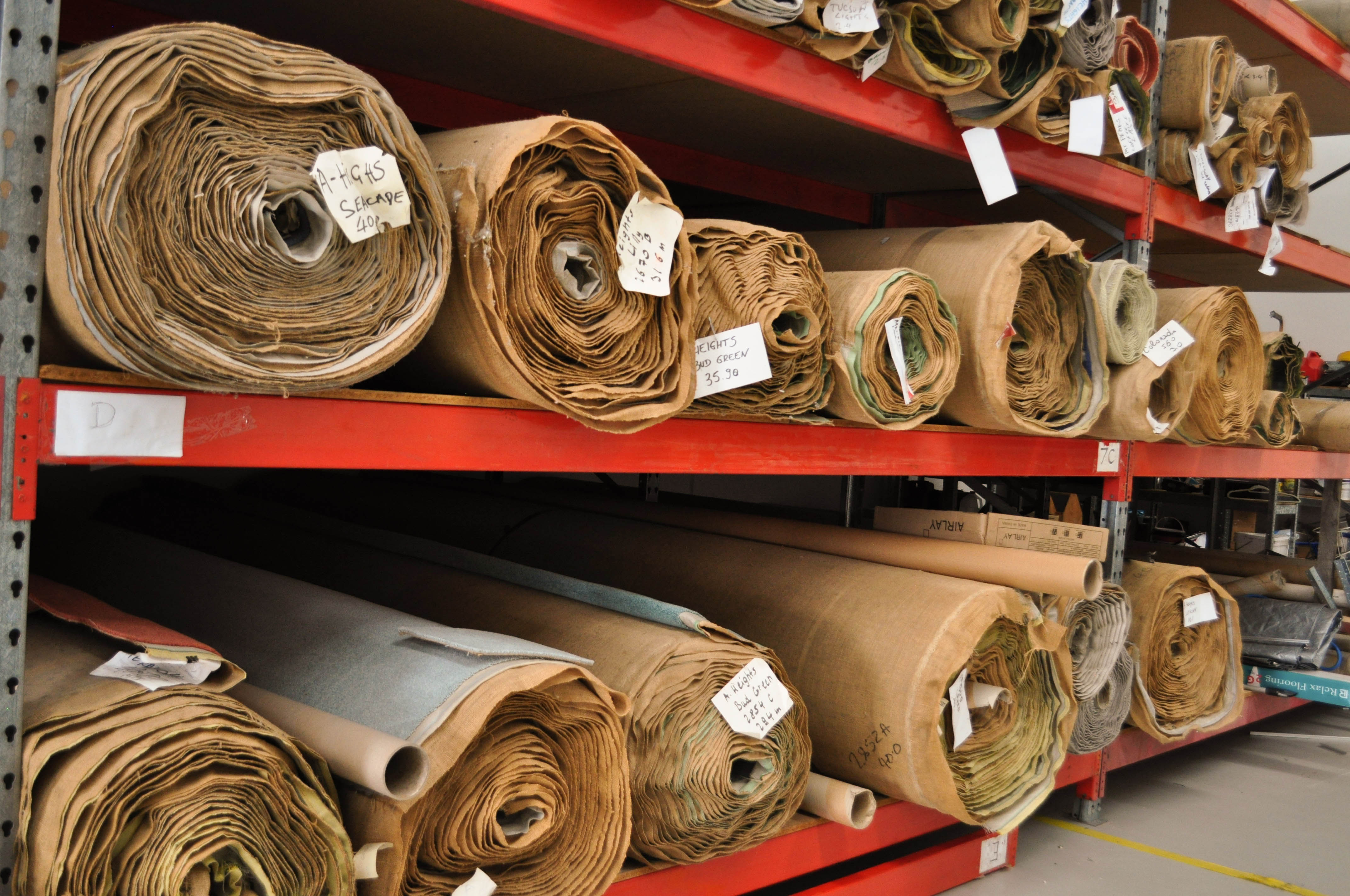 Concord Floor's warehouse storage facilities showing carpet storage racks with rolls of carpet in them