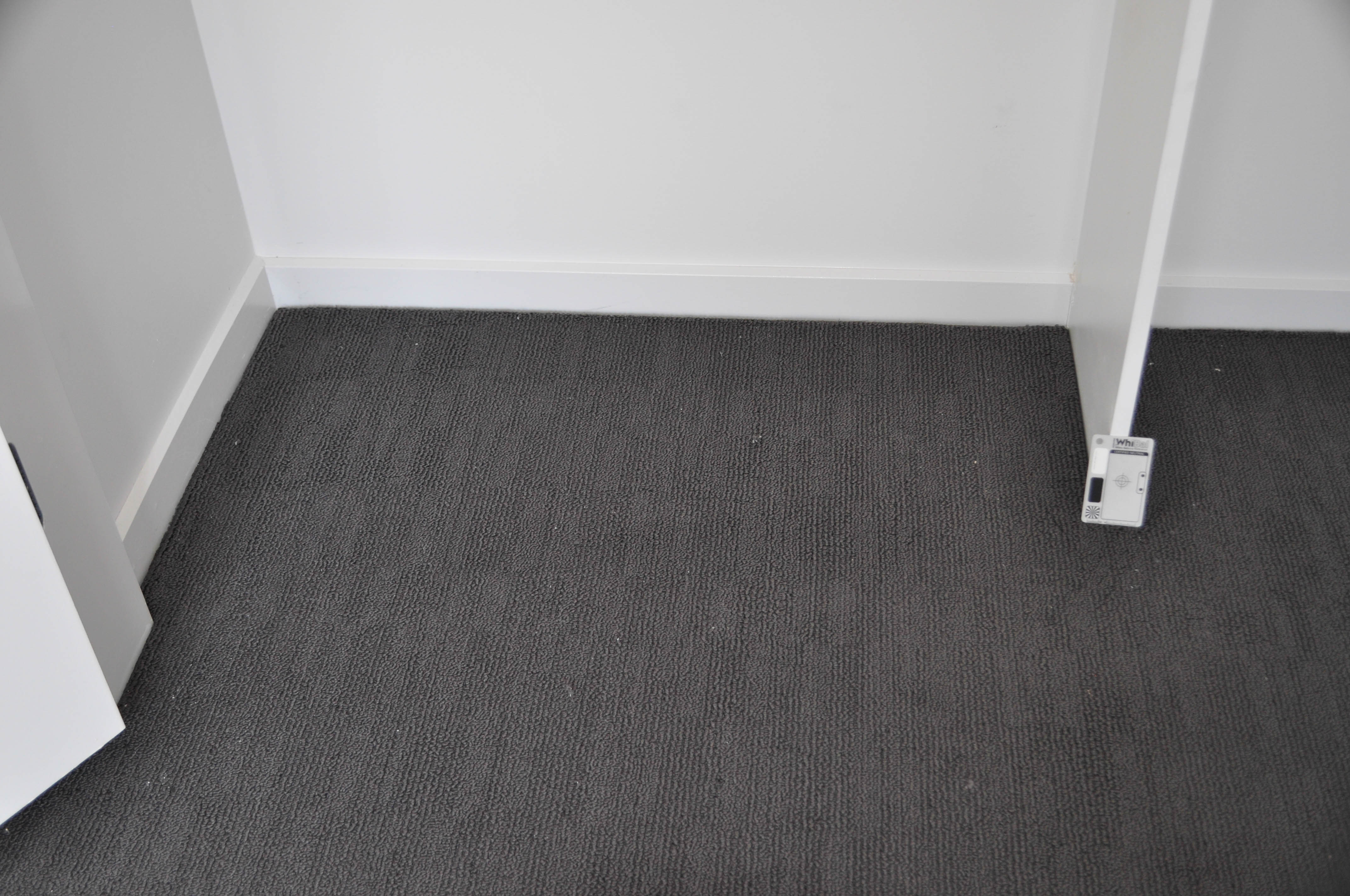 showing a bedroom wardrobe where the floor has been carpeted with a charcoal patterned carpet.