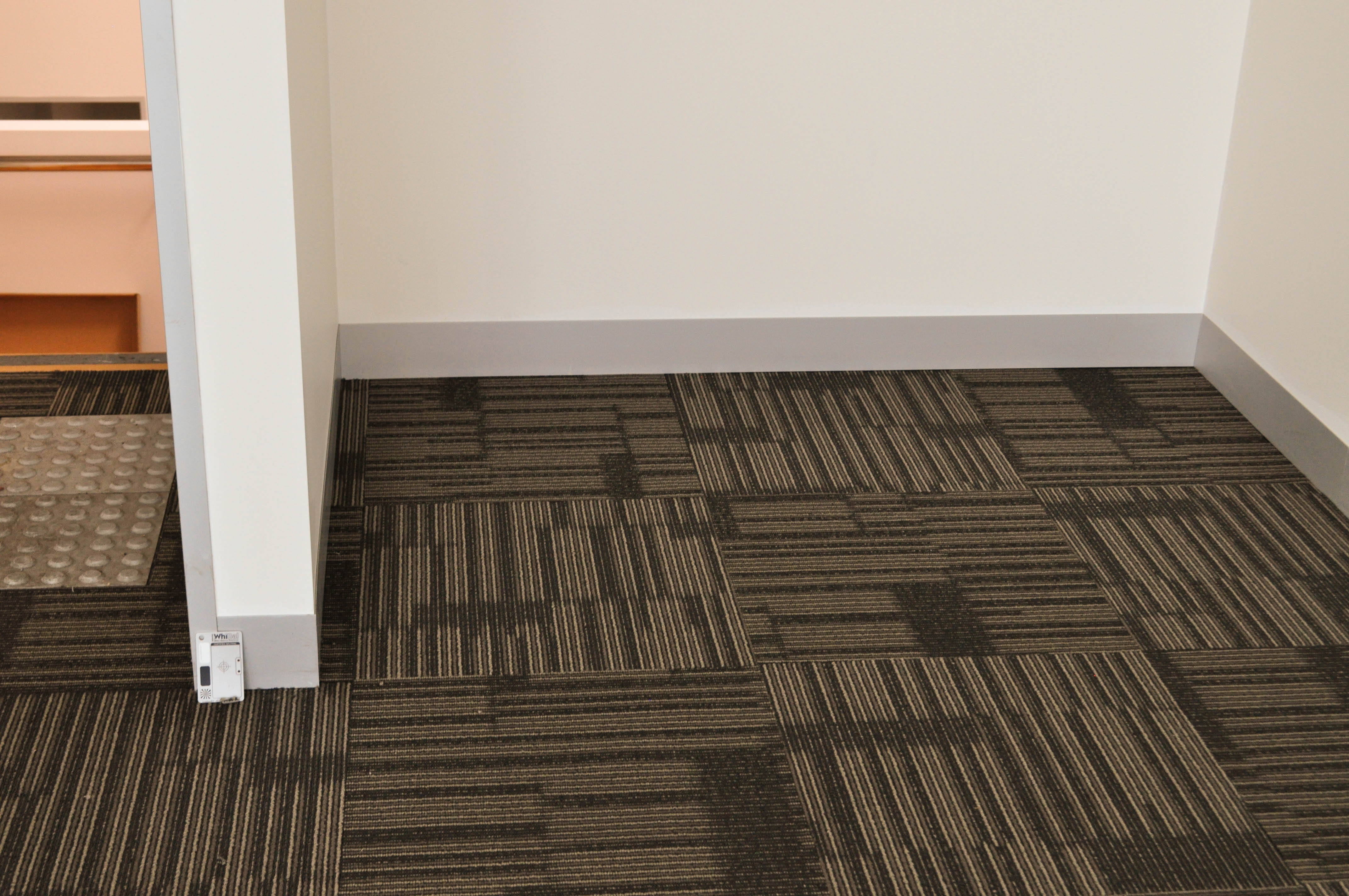 Showing a floor that has a patterned carpet tile installed by Concord Floors on it. The building is in Derrimut.