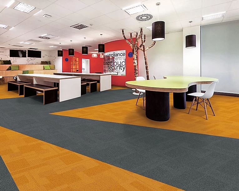 patterned, grey colored and yellow colored square carpet tiles are laid on the floor which are sold and installed by Concord Floors