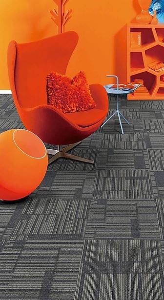 patterned,  colored, carpet tile of the  range called SIESTA on sale at Concord Floors installed in a room.