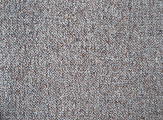 grey colored, wool fibre, level loop-pile carpet. A sample of the carpet.