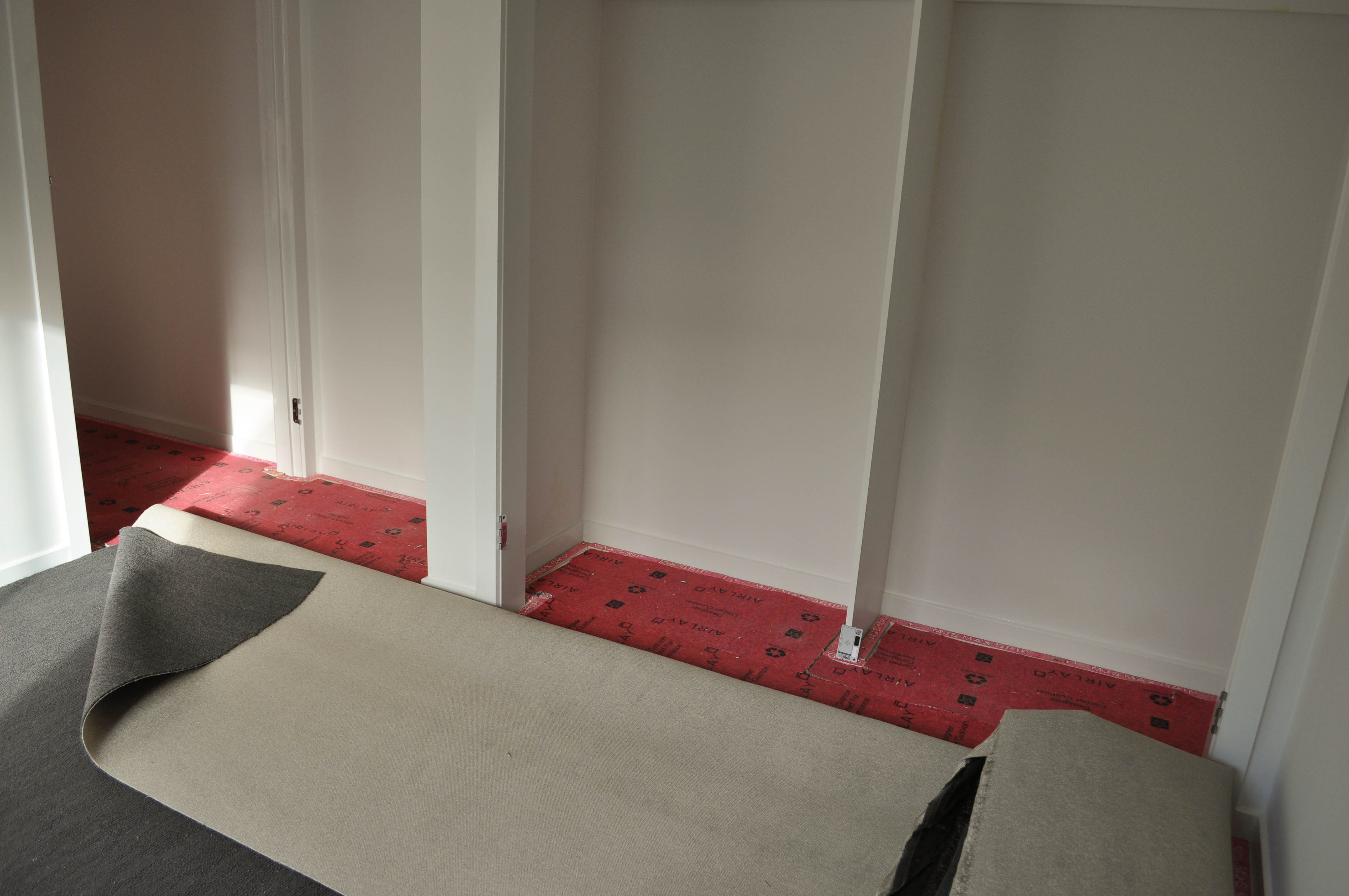 shows a floor in a wardrobe in a bedroom room in a residential home, where the carpet flooring installation process is under way 
	  in Werribee, Melbourne, Victoria 3030, Australia