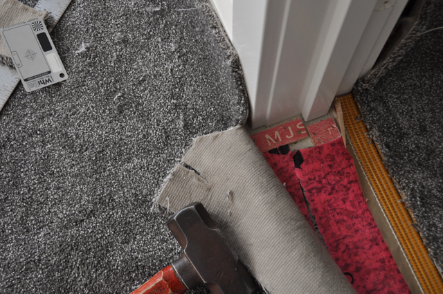 showing 2 bodies of carpet in place over underlay and stretched out that are positioned  next to each other in a doorway between 2 rooms
 ready to be joined and bonded together with the heatbond adhesive tape on top of the underlay and under the carpet where the join will occur. The rows of pile where the two carpets
 will connect when joined are intack and unsavaged which produces a top join.
