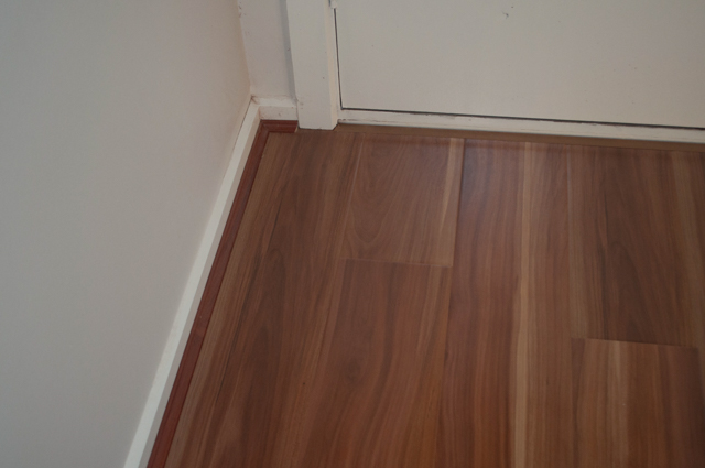 red colored 12mm thick laminate flooring installed in a passage in the suburb of Bacchus Marsh Vic 3340 by 
  Concord Floors who also supplied the floor.
