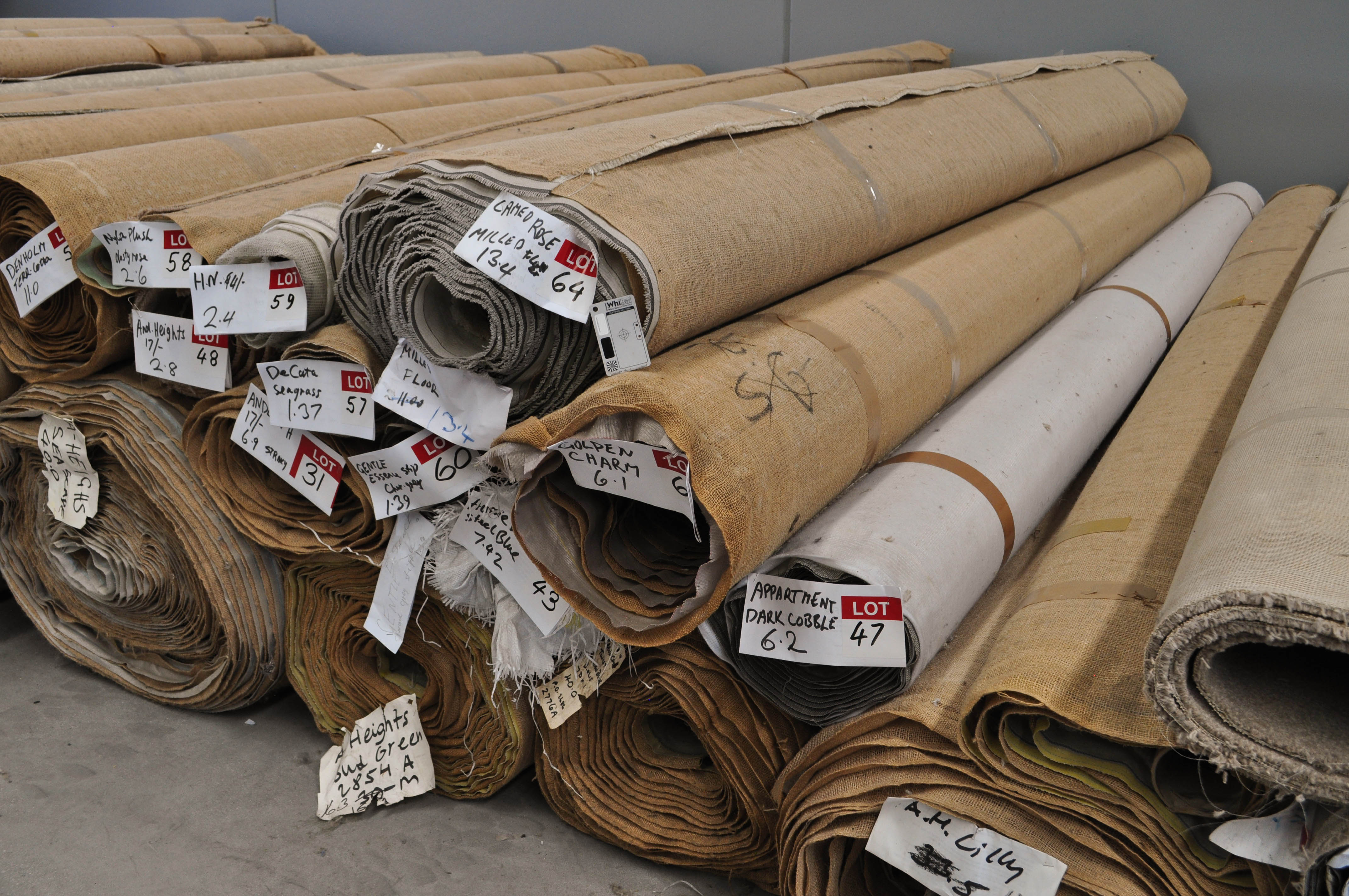 a stack of many different sizes of many carpet rolls neatly stacked on the concrete floor of the warehouse of Concord Floors in Derrimut.
This stack of carpet rolls is from which customers can pick their carpet from in their project of carpet installation.