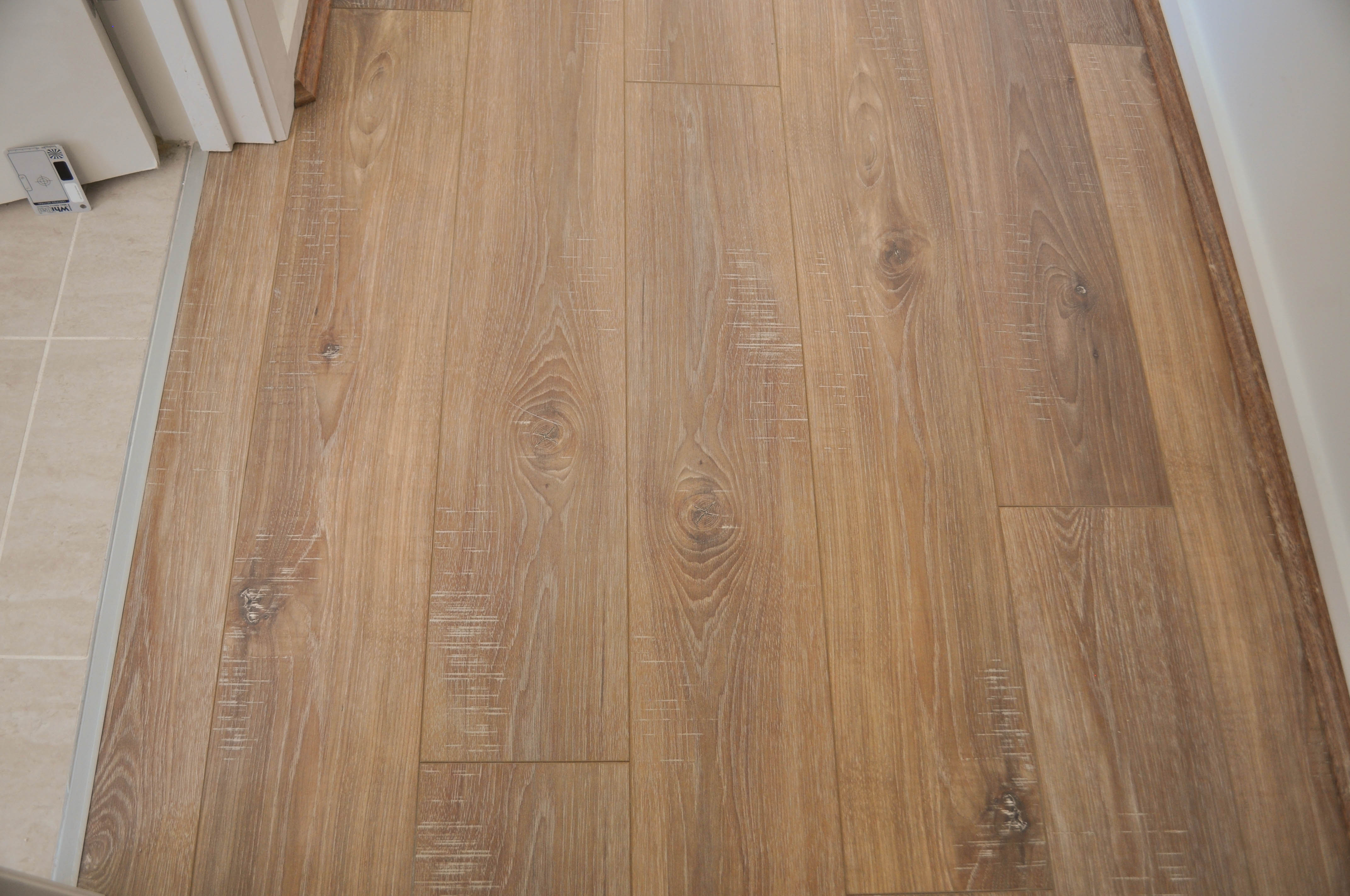 a photo of sample board of oak laminate flooring, 12mm thick laminate flooring  board, of a particular brand (aged oak)
 available to the public to buy Concord Floors and if they wish have it installed by Concord Floors.