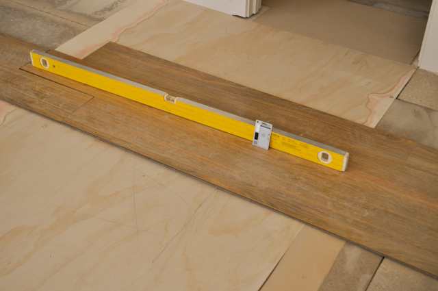 a room where the sub-floor has been leveled by placing a 3mm thick plywood sheet to fill the low spot in the floor.
 The floor was then sanded and some spotted gum floorboards were laid over the plywood filling and the sanded floor. The picture shows a spirit level on top of a spotted gum
 laminate flooring' in that room in order to check the levelness of the newly levelled floor. This work of leveling the floor was done by Concord Floors in the suburb of 
 Point Cook, Werribee Vic 3030.
