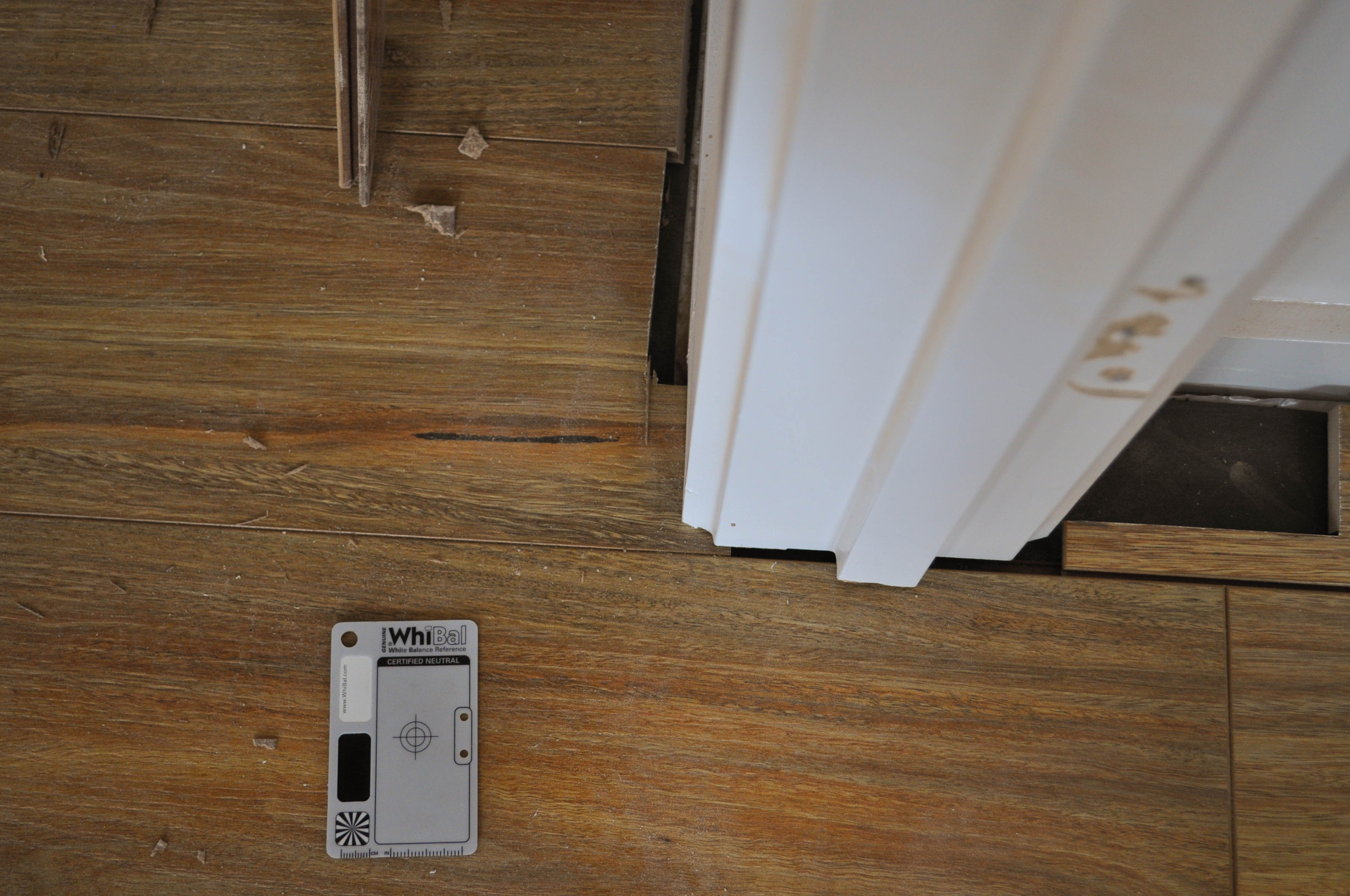This picture shows 12mm thick, Spotted Gum laminate floorboard flooring. The first row of floorboards has as it's first board a 
board that need to be notched that has been notched and tapped into it's permanant place in the floor, being installed in two rooms in the suburb of Point Cook, Werribee Vic 3030
 by Concord Floors. The door jamb has been undercut and a cavity created to receive the notched board. the result is an elegant finish where by the bottom of the door jamb 
 and the top of the board meet perfectly leaving no ugly gaps. This is information as to how to install laminate flooring for the do it yourself floor board laminate flooring
 installer.