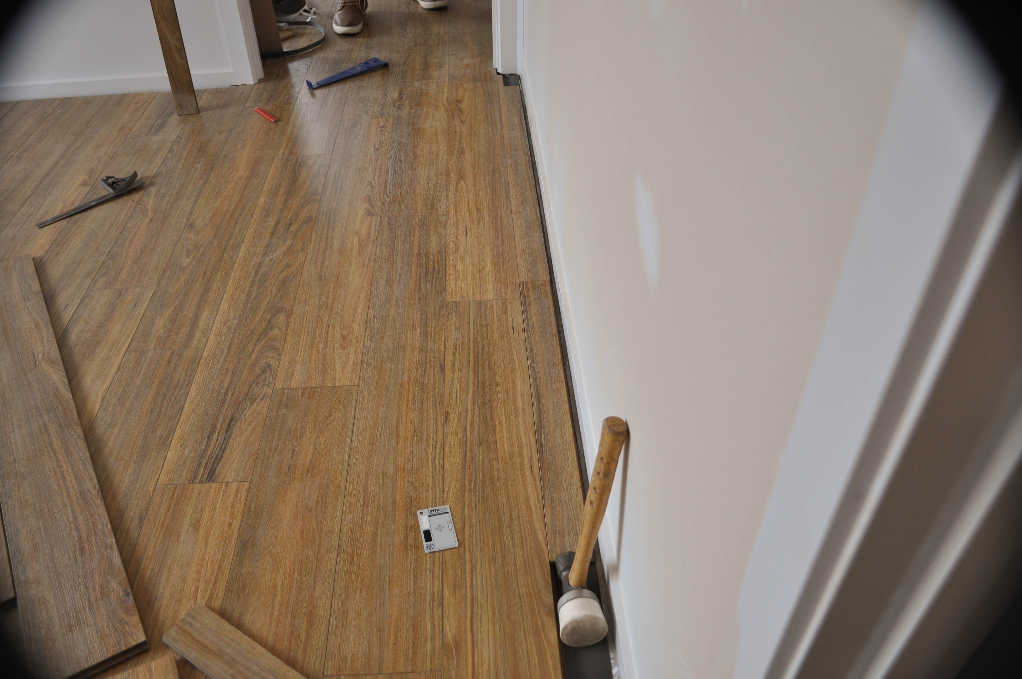 the picture shows the ripped boards being fitted into the floor as the last row of floorboards between the laminate floor and the 
  wall after leaving a 10mm expansion gap. The room shows installed, 12mm thick, Spotted Gum laminate floorboards covering the floor and the last row of boards being hammered into 
  place and position. The room in the suburb of Point Cook, Werribee Vic 3030 by Concord Floors and the boards were supplied and installed by Concord Floors. This is information
   as to how to install laminate flooring for the do it yourself floor board laminate flooring installer.