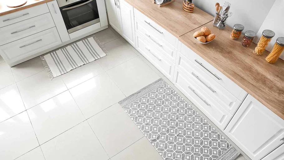 showing a kitchen with tile flooring and kithen cabinets