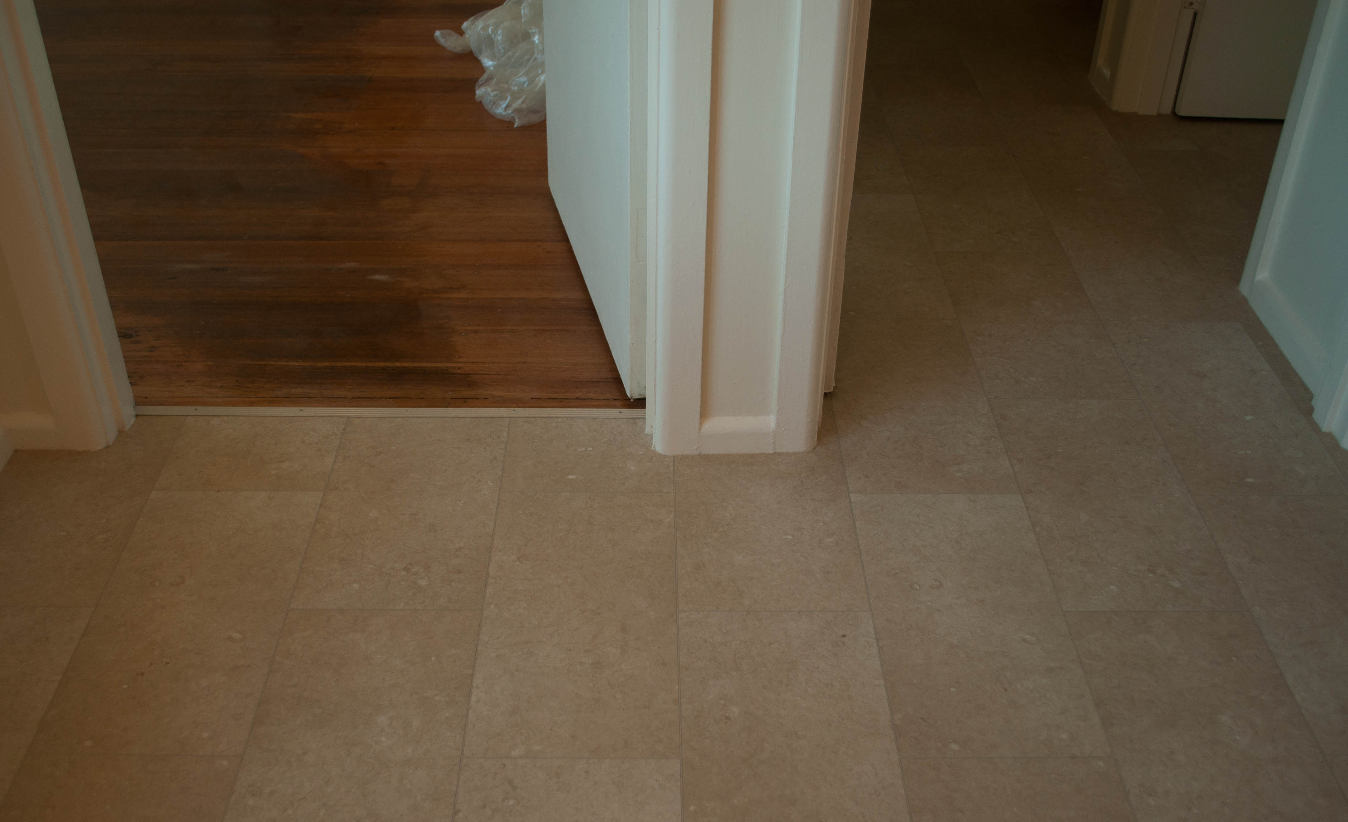 showing a dommesitic vinyl with a tile look pattern on its surface with beige colors, installed in a kitchen , by
          Concord Floors, in a home in Melton, Vic 3337.