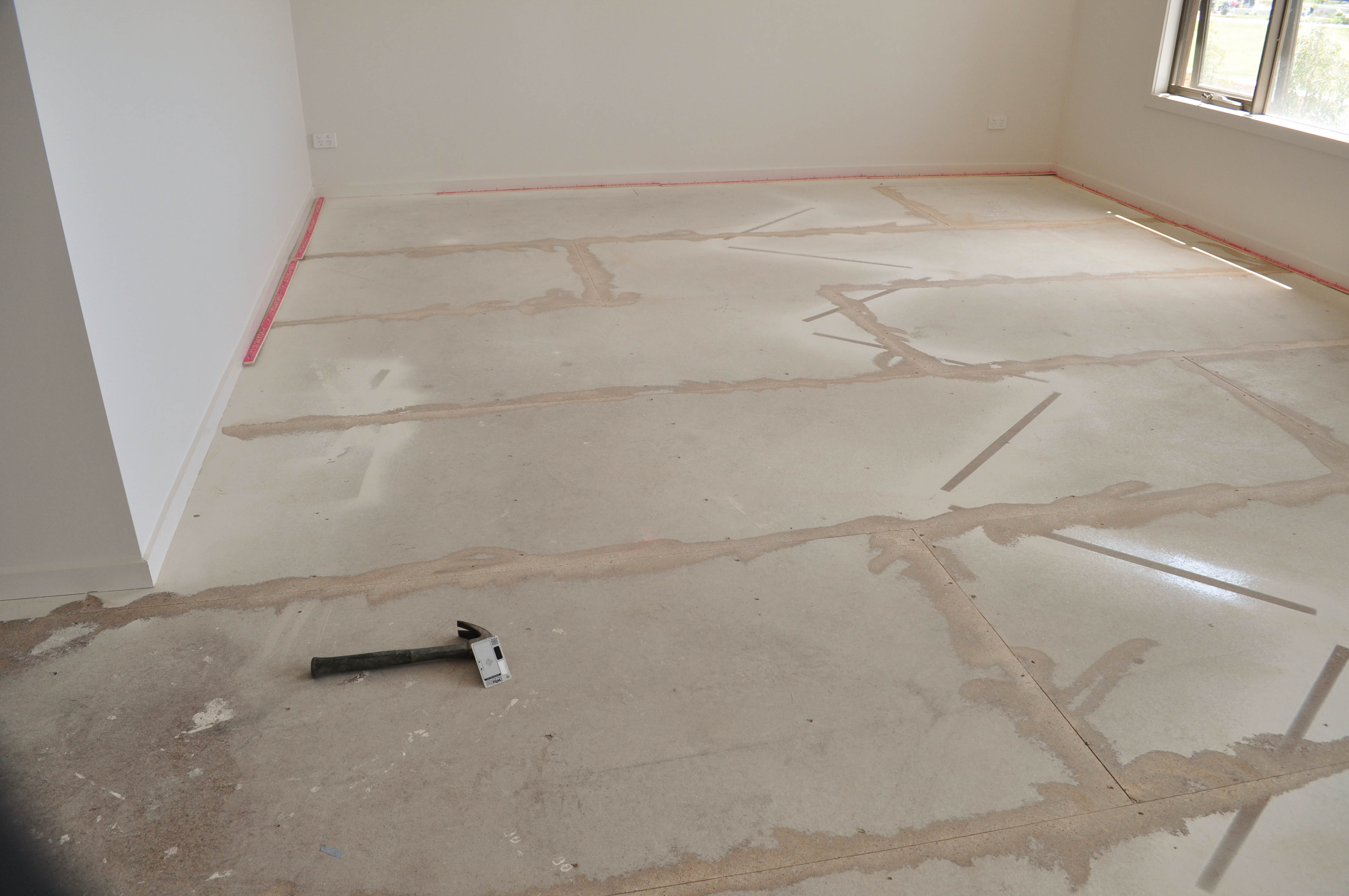 a floor in a room, in a house in Point Cook, Werribee where the timber floor boards have cupped and the
 cupping has been sanded down with an edge sander  Concord Floors.