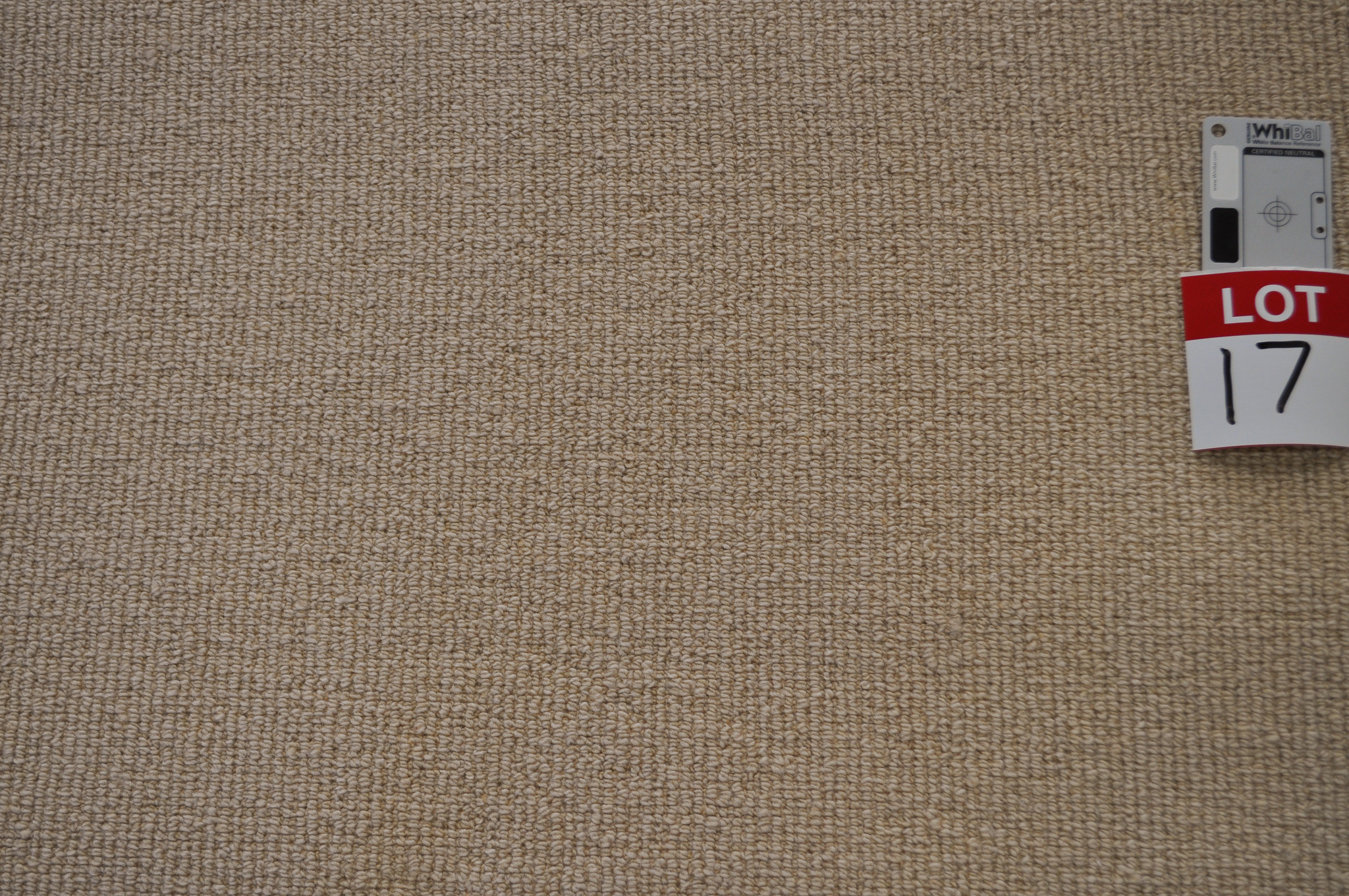 yellow beige colored, sisal pile, roll of carpet on sale at Concord Floors, it being a remnant roll in Concord Floor's warehouse.