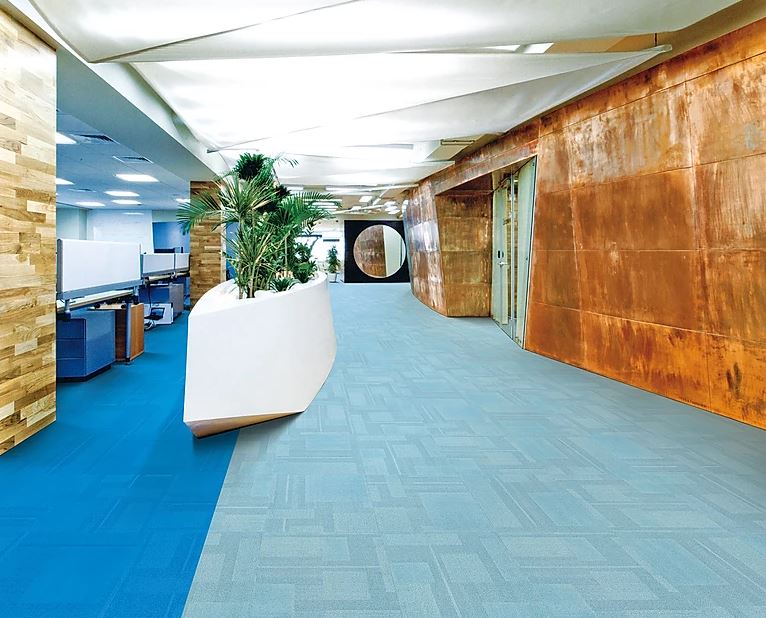 patterned, colorful carpet tiles in the color blue installed in a commercial office of the  PENTLAND on sale at Concord Floors.