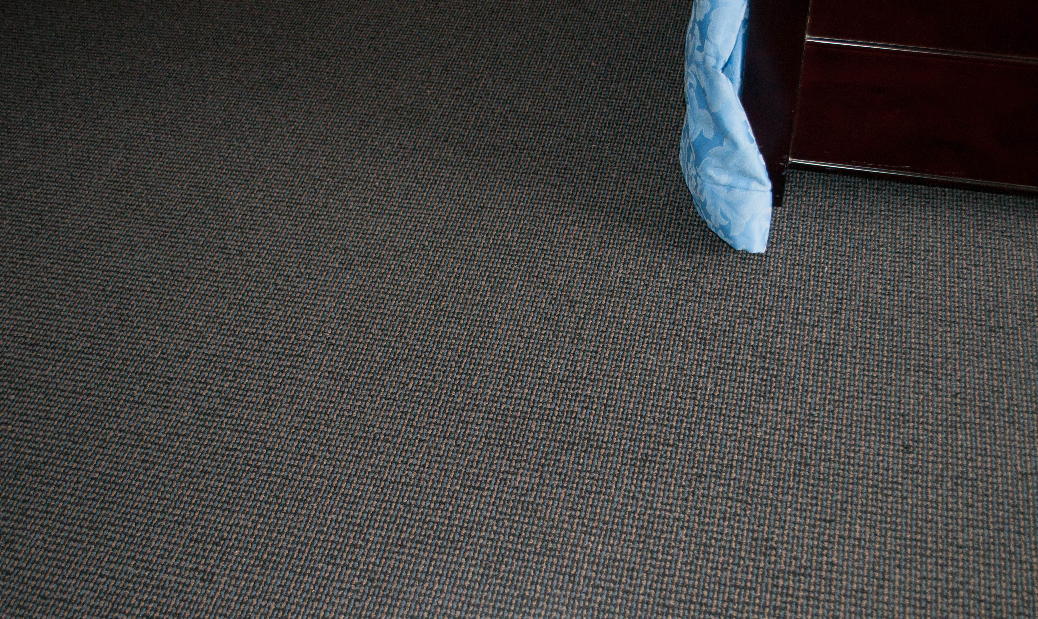showing a bedroom which has its floor covered by a patterned carpet in a home in Melton which was installed by Concord Floors. The carpet and
 its color belong to a range of carpets which are available to the public to buy from Concord Floors. The carpet range is Kalisari and the carpet is for sale to the
 public.