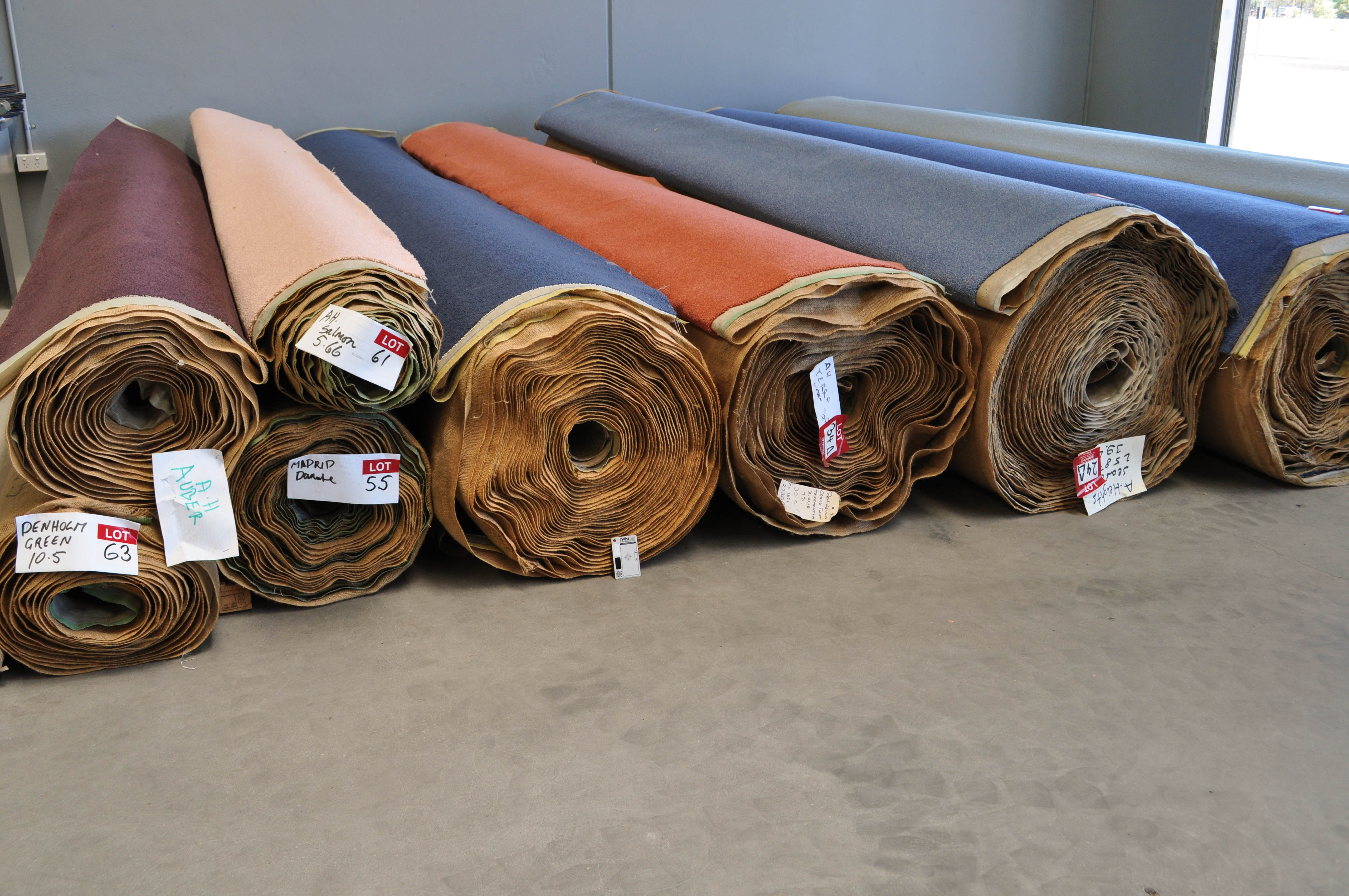 a stack of many different sizes of many carpet rolls neatly stacked on the concrete floor of the warehouse of Concord Floors in Ravenhall, Caroline Springs.
This stack of carpet rolls is from which customers can pick their carpet from in their project of carpet installation. This stack is of high quality wool carpet