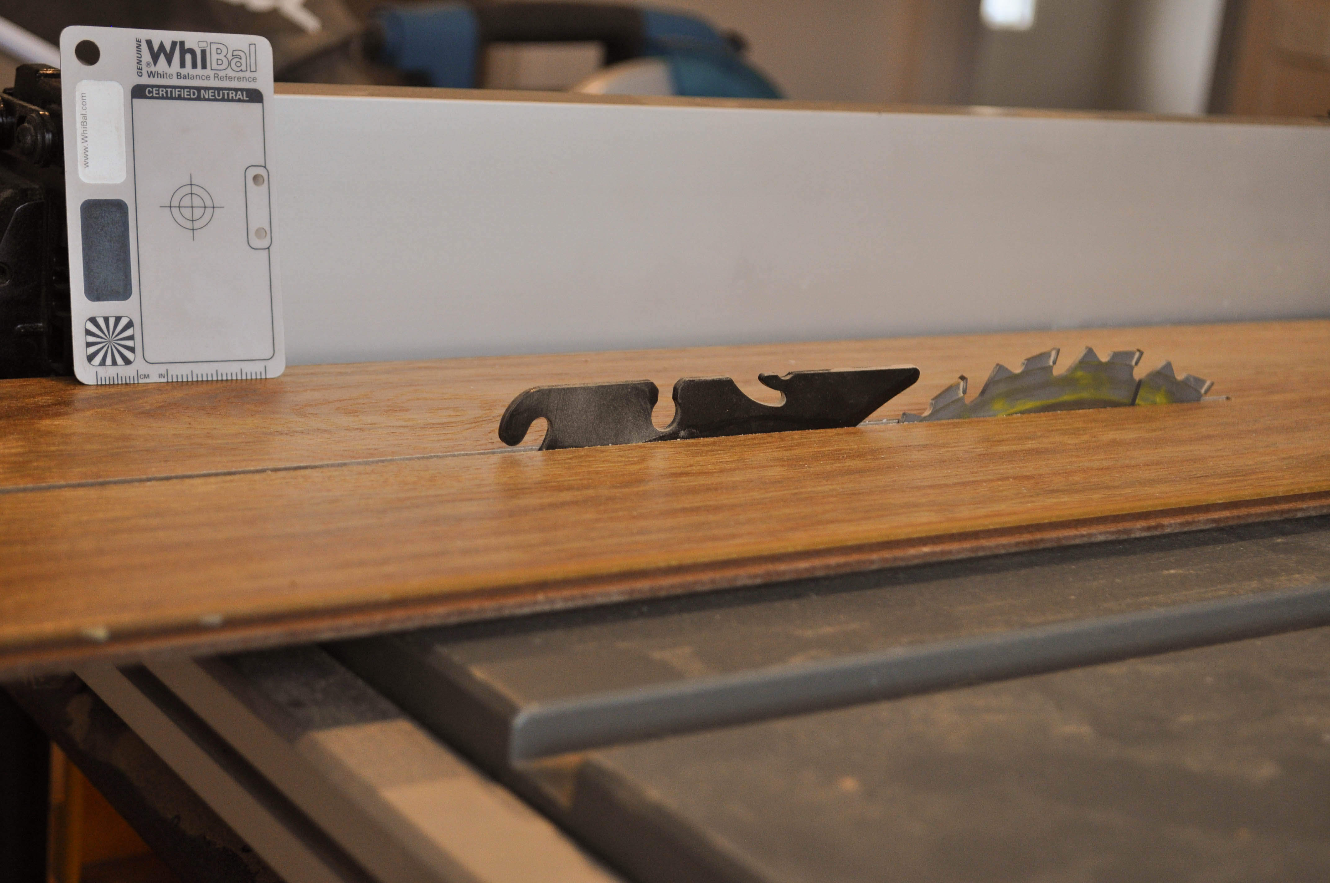showing a 12mm thick spotted laminate floor board on top of a table saw being ripped (or sliced lengthwise) prior to its 
  installation in the flooring of the room. This is necessary because the last board doesn't and must have the excess removed in order for it to fit in the room. With the table saw 
  the picture demonstrates the ease and speed with which the boards can be laid and therby it's competitiveness with other flooring materials. The a home in the the suburb of
 Werribee Vic 3340 and the laminate floor was installed by Concord Floors.